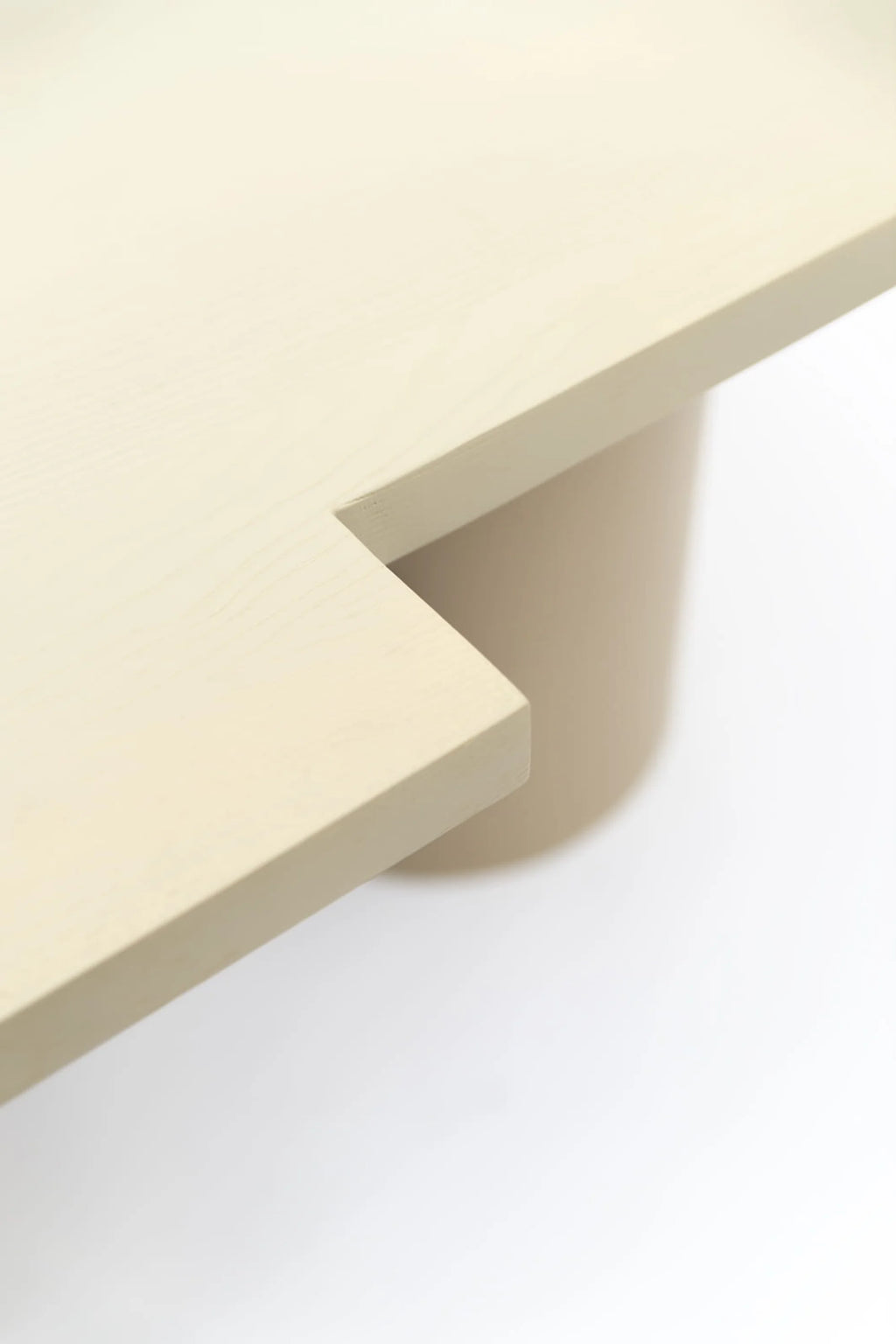 NG DESIGN Object 098 Dining Table, featuring a minimalist design with a light beige, rectangular tabletop and a subtly angled cutout corner on a cylindrical base. This luxury piece is ideal for modern dining spaces.