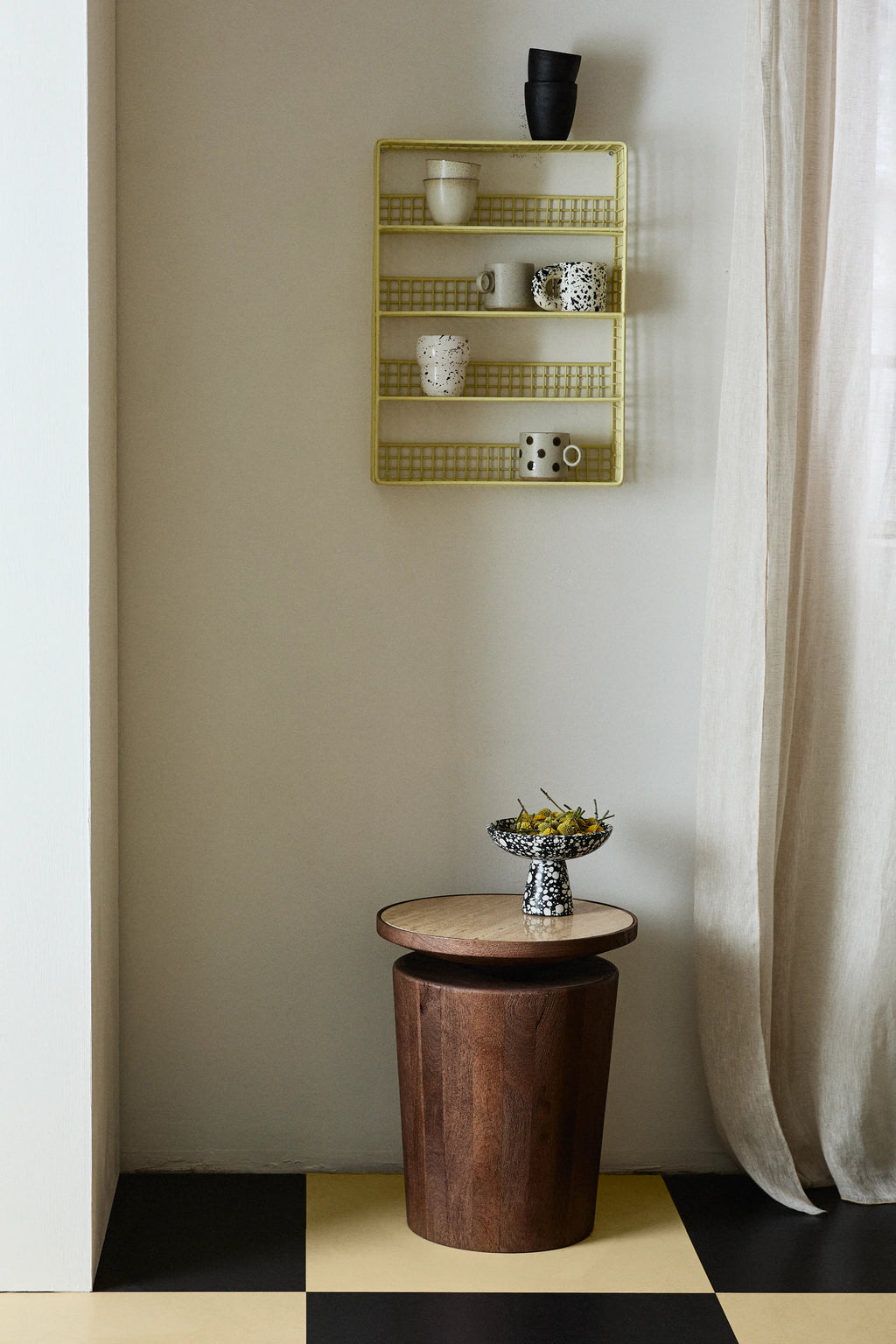 Nordal Kwando Side Table, a striking organic modern accent table featuring a robust cylindrical base crafted from rich dark solid wood with visible grain texture.