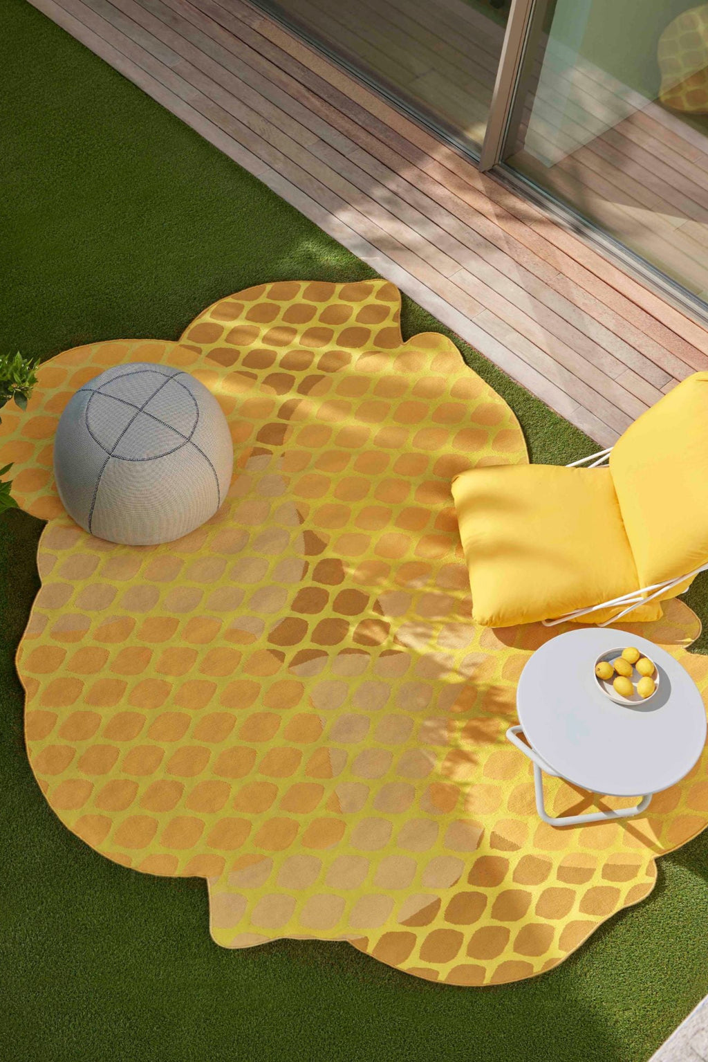 GAN Rugs Citrus Outdoor Rug, a vibrant lemon yellow and golden-toned outdoor area rug featuring a playful, irregular fruit-inspired shape and a distinct segmented pattern resembling a sliced citrus fruit. Crafted from durable weather-resistant fibers, this contemporary outdoor rug is perfect for adding a pop of color and organic modern style to a patio, balcony, or garden living space.