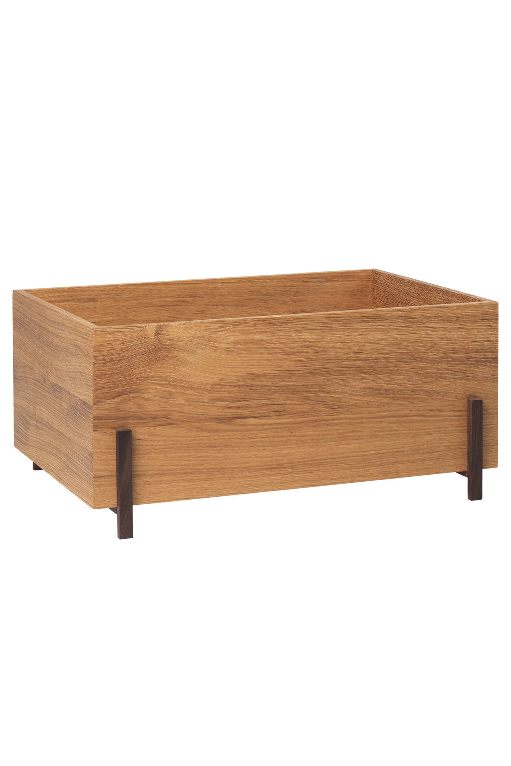 Kristina Dam Stack Storage Box - Set of 3, a modern minimalist rectangular storage box crafted from natural solid oak wood with a light brown hue and visible grain texture, subtly elevated on slender dark wood legs. This Scandinavian-inspired wooden organizer offers a clean, contemporary aesthetic.