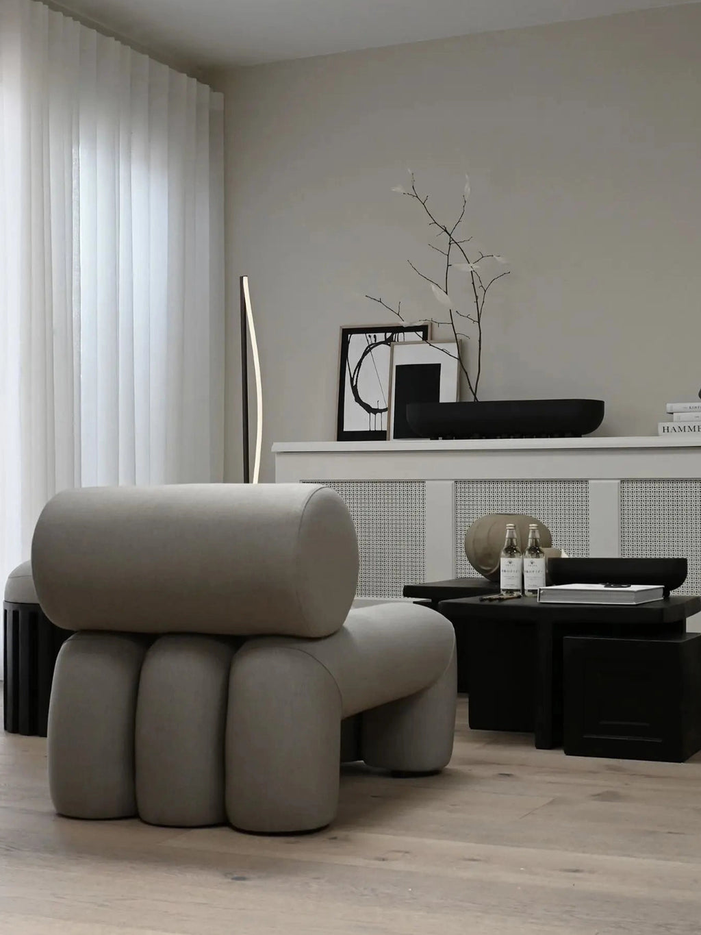 101 CPH Foku Lounge Chair in a modern living room setting. This designer chair features a unique modular light beige upholstered silhouette with thick, rounded sections. A premium statement piece for contemporary interiors.