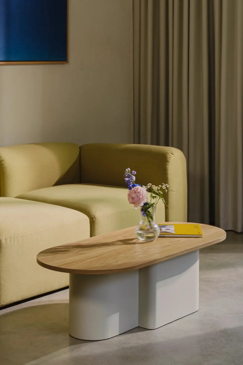 noo.ma Flom 2-Seater Sofa, a contemporary modular sofa upholstered in a soft chartreuse green textured fabric, featuring a low-profile design and inviting rounded corners. This modern minimalist two-seater sofa provides plush, comfortable seating for a stylish living room or organic modern apartment.