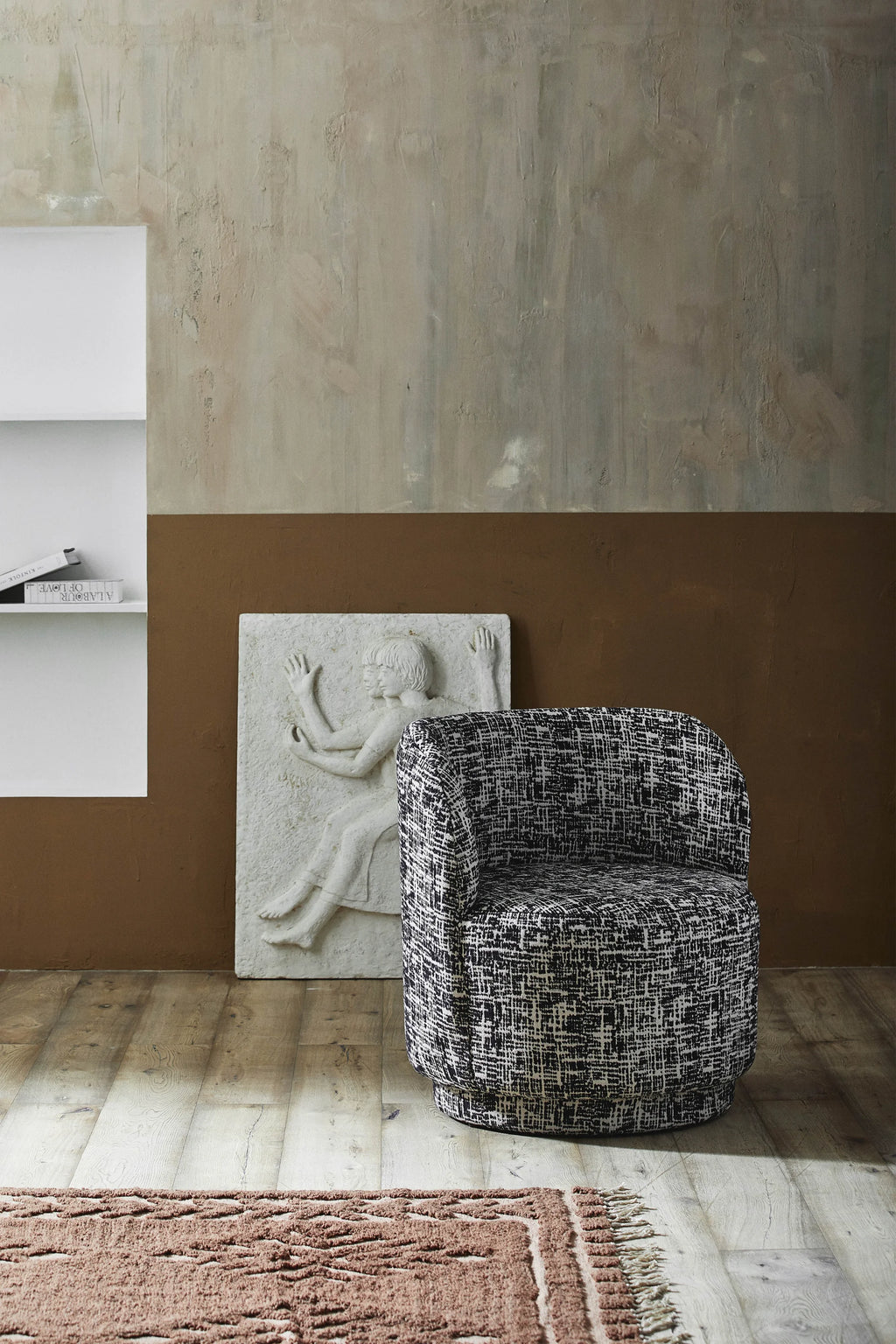 Nordal Bomu Lounge Chair, a modern minimalist armless accent chair featuring a curved, organic silhouette upholstered in a plush, textured black and white bouclé fabric.