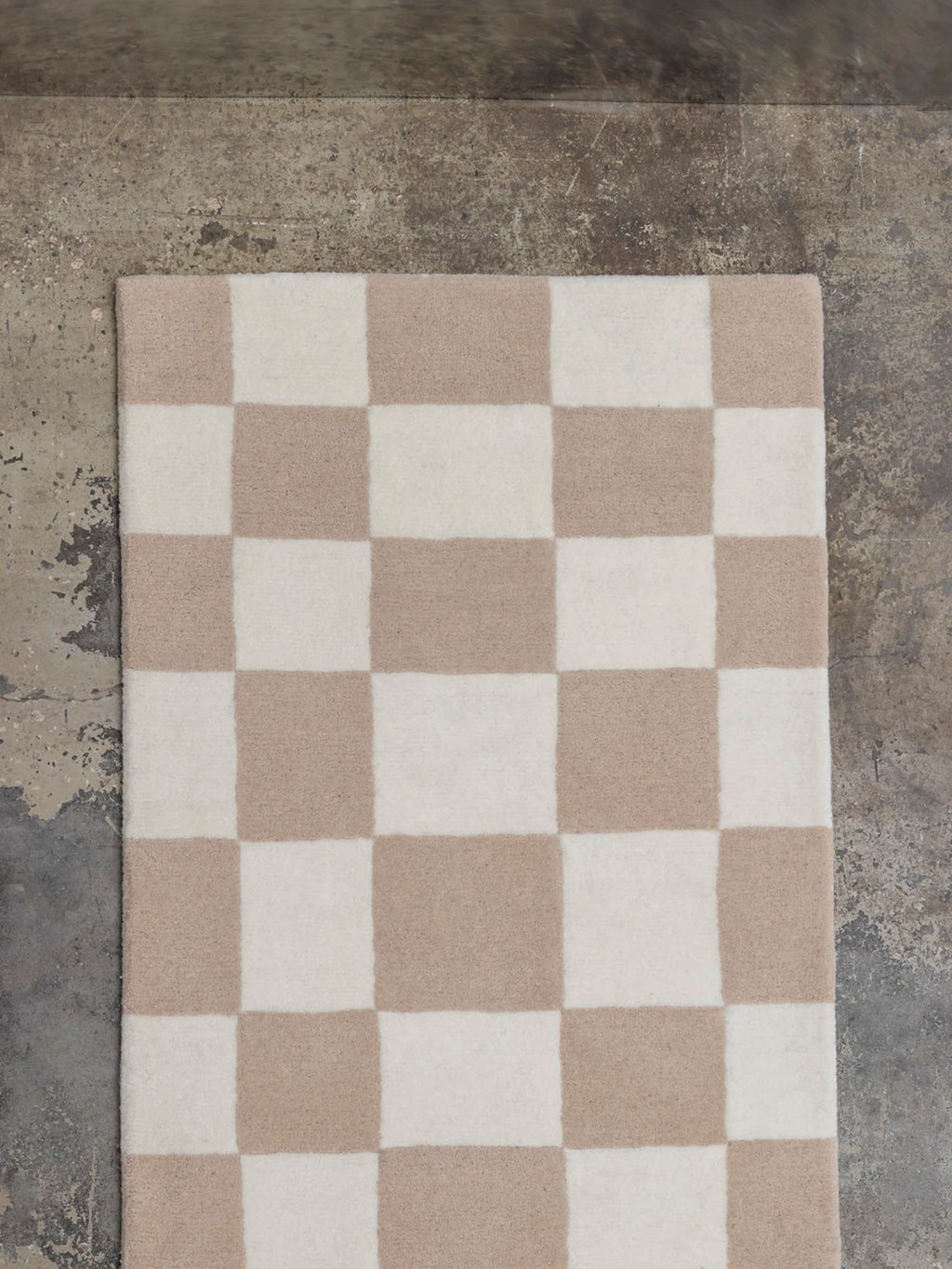Tinted Objects Hafstrom Wool Runner Rug, featuring a checkerboard pattern in soft beige and creamy off-white, crafted from luxurious, plush wool. This stylish, durable rug is ideal for adding warmth and modern elegance to hallways and entryways in contemporary homes.