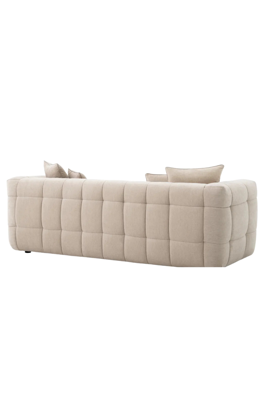 Eichholtz Breva Sofa, a contemporary beige upholstered sofa featuring a distinctive square tufted and quilted design with plush, rounded cushions and a low profile. This modern fabric sofa in a natural cream tone offers luxurious comfort and a clean, inviting aesthetic. Perfect for minimalist living rooms and chic contemporary spaces seeking a statement piece.