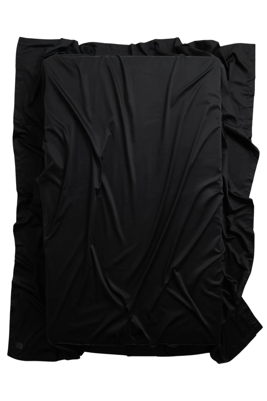 Magniberg Mother Sateen Flat Sheet, a luxurious deep black sateen flat sheet crafted from smooth, lustrous cotton sateen with a fluid drape and subtle sheen. This high-quality black bedding offers a soft, elegant touch, perfect for creating a sophisticated modern minimalist bedroom or a contemporary luxury sleeping space.