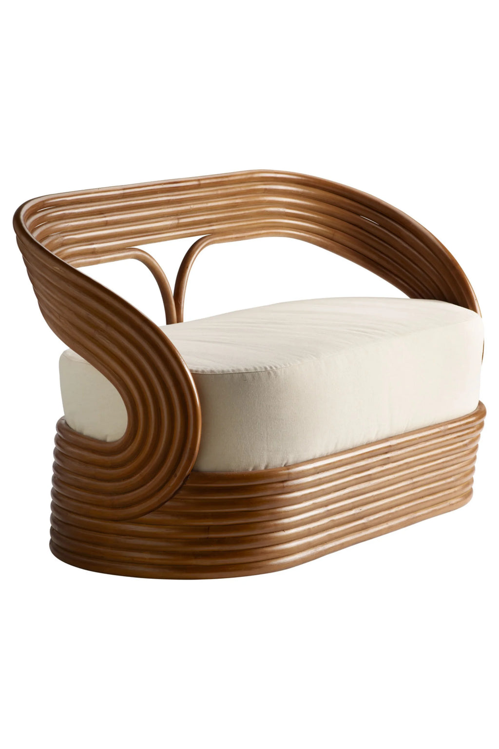 Tine K Mano Sofa, an organic modern lounge sofa crafted from beautifully bent natural rattan in a warm brown finish, forming a continuous, curved silhouette with layered ribbed details. It features a plush cream upholstered cushion, offering a comfortable and stylish seating option. Ideal for coastal, bohemian, or contemporary living rooms and sunrooms.