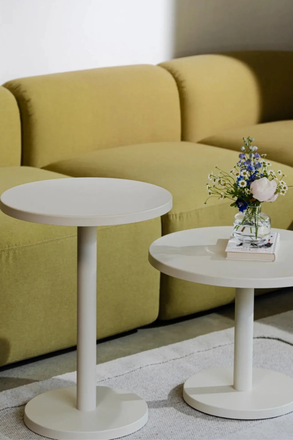 noo.ma Flom Corner Sofa, a contemporary modular sofa featuring a low-profile design with plump, rounded cushions and a soft, inviting silhouette, upholstered in plush chartreuse green textured fabric. This organic modern sectional offers clean lines and a relaxed aesthetic, perfect for modern minimalist living rooms and contemporary lounge spaces.