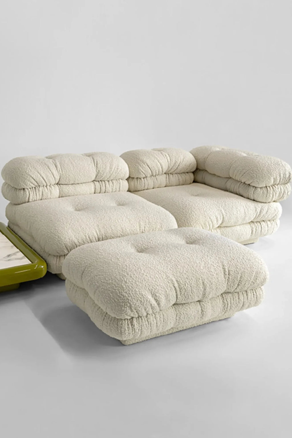 Hessentia Lowell Modular Sofa, a luxurious cream bouclé modular sofa featuring deep, plush tufted cushions and a cloud-like, organic modern silhouette. Its inviting off-white textured bouclé fabric and rounded forms create a cozy yet sophisticated lounge seating experience, complete with an accompanying modular ottoman. Ideal for contemporary living rooms, minimalist spaces, or as a statement piece in an organic modern interior.