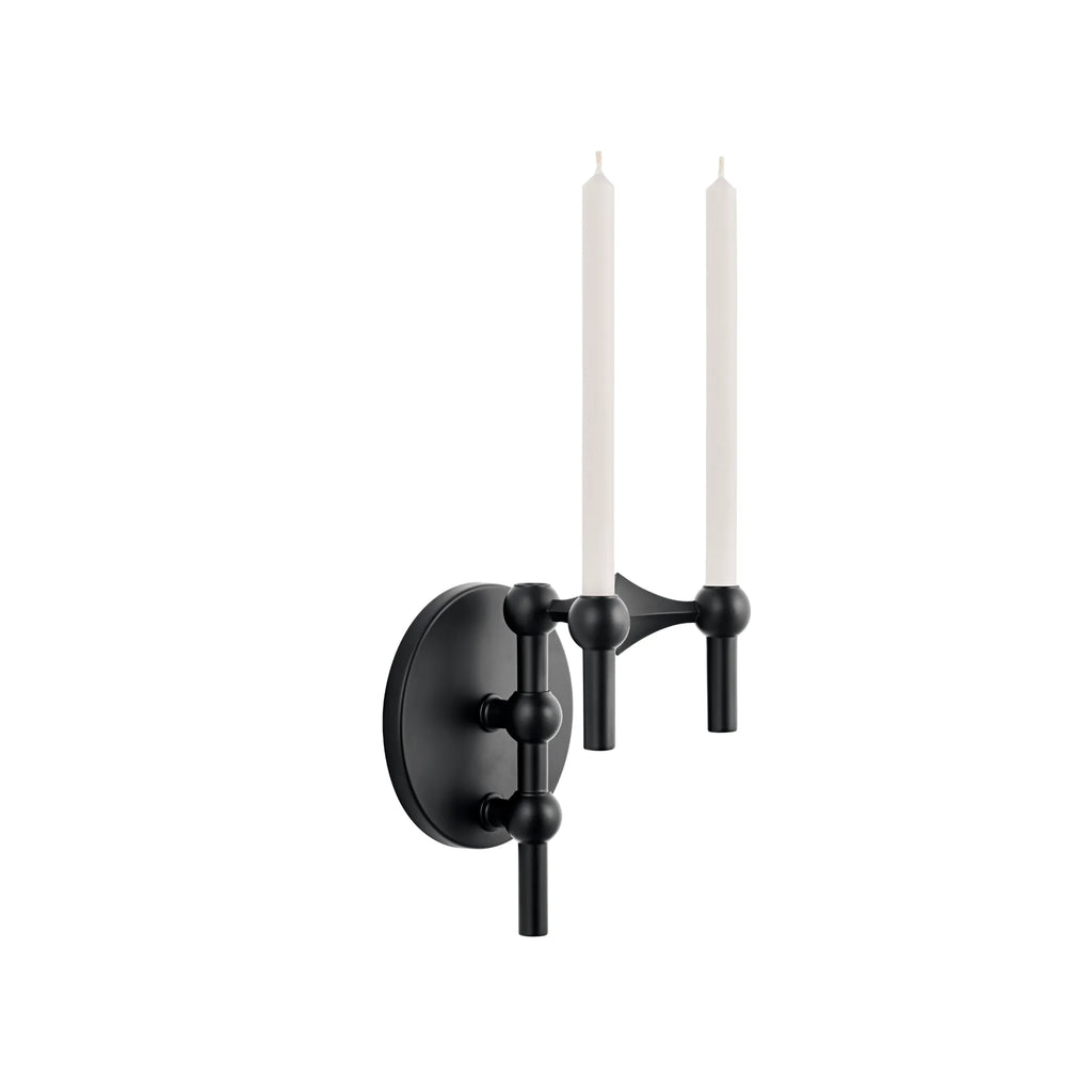 Stoff Nagel Wall Hanger Candle Holder - Black - Configuration 1, a sleek modular wall-mounted candle holder featuring a matte black metal finish with spherical accents and two arms designed to hold tapered white candles. This contemporary sculptural piece offers a modern minimalist aesthetic, crafted from durable matte black metal. Ideal as a statement wall sconce or decorative accent for living rooms, entryways, or contemporary dining spaces.