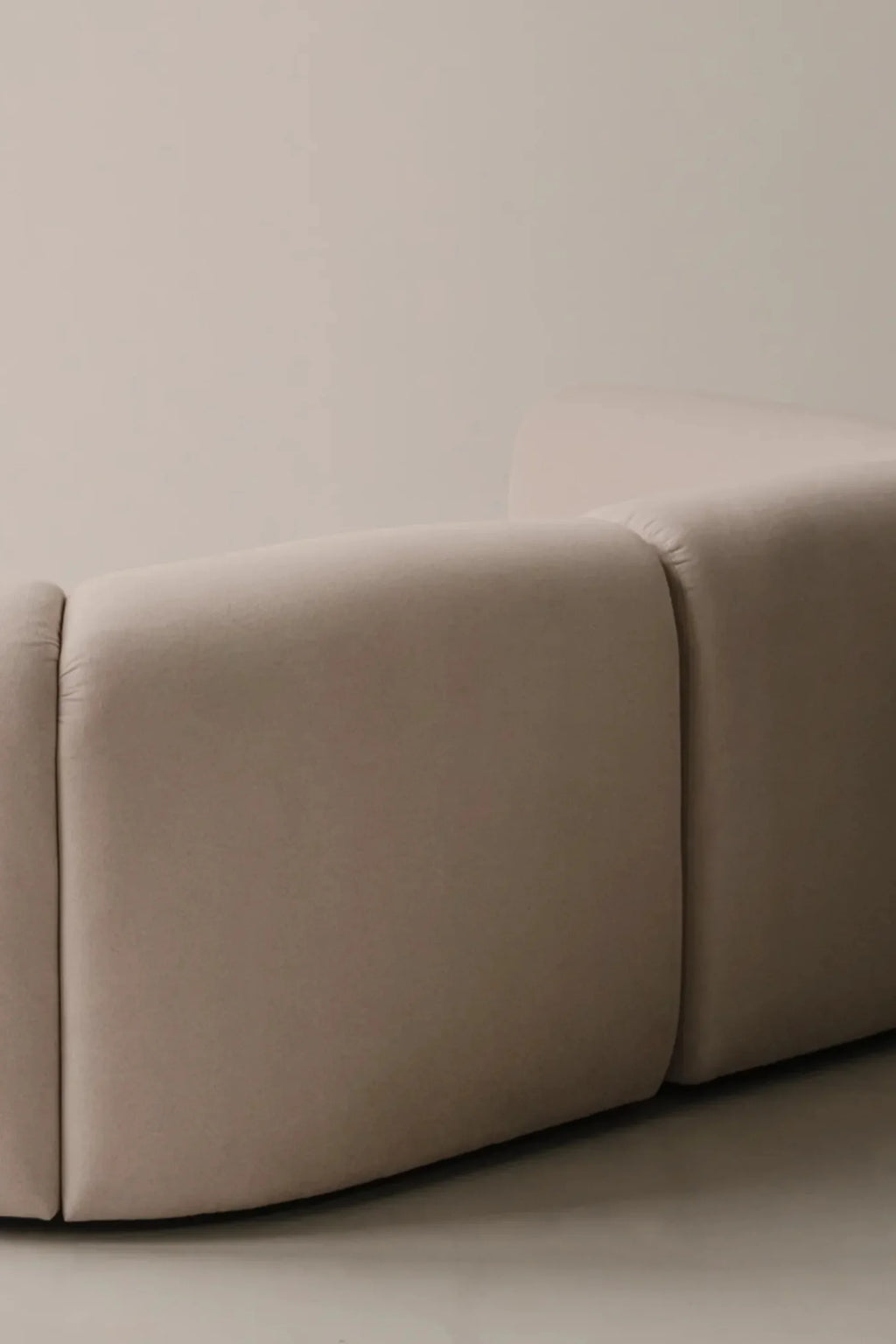 noo.ma Flom Corner Sofa, an organic modern modular sofa featuring a soft, neutral light beige upholstery with distinct, rounded modules and a plush, inviting texture. This contemporary sectional creates a flexible and stylish seating arrangement, ideal for minimalist living rooms or Japandi-inspired lounge areas.