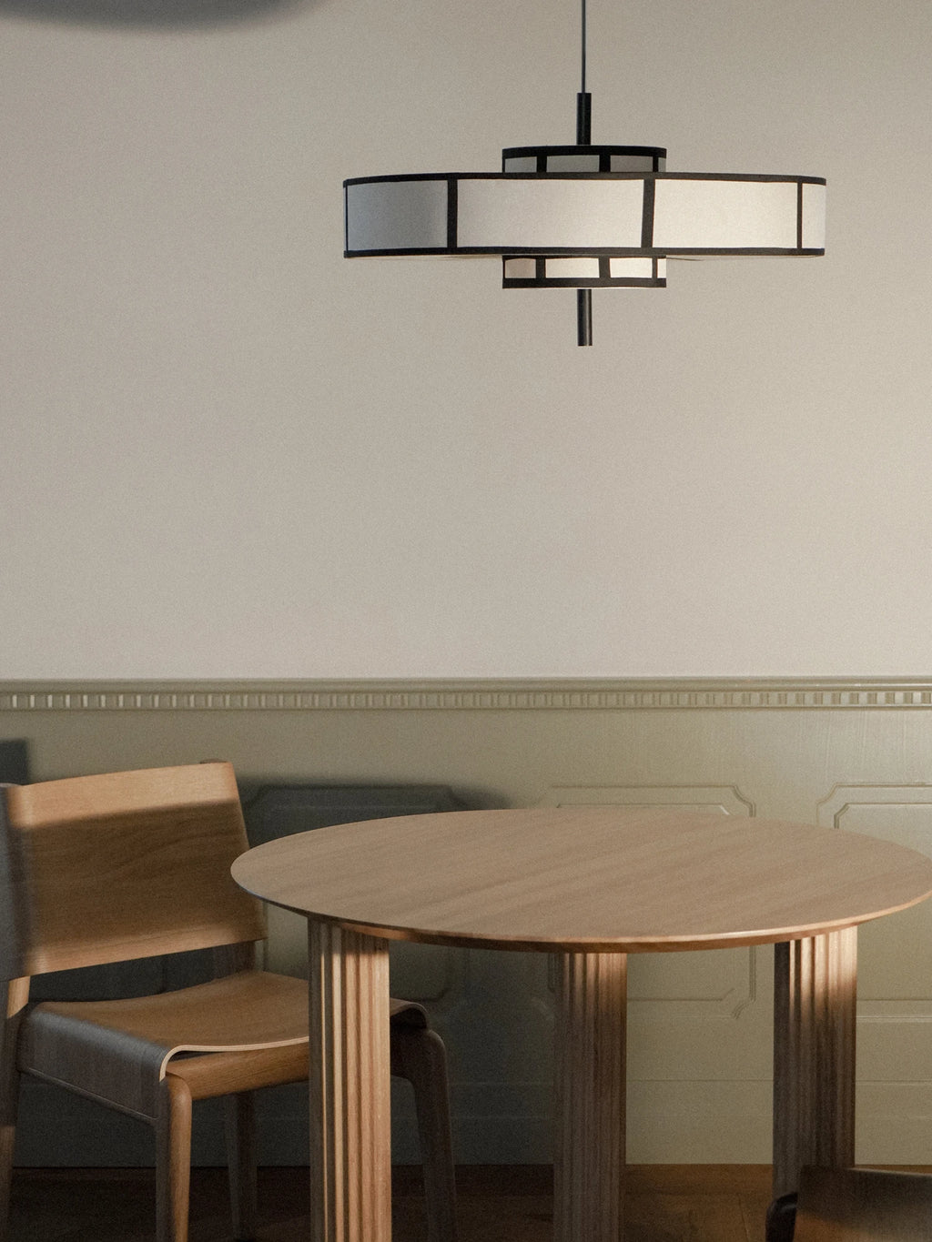 TAMO Aura Pendant Lamp 60, a striking Art Deco-inspired tiered pendant lamp featuring a bold black metal frame with geometric lines and contrasting white fabric diffuser panels. Its multi-level design creates a sophisticated, diffused glow, blending classic elegance with contemporary style. Ideal as a statement ceiling light for modern dining rooms, luxurious living spaces, or grand entryways.