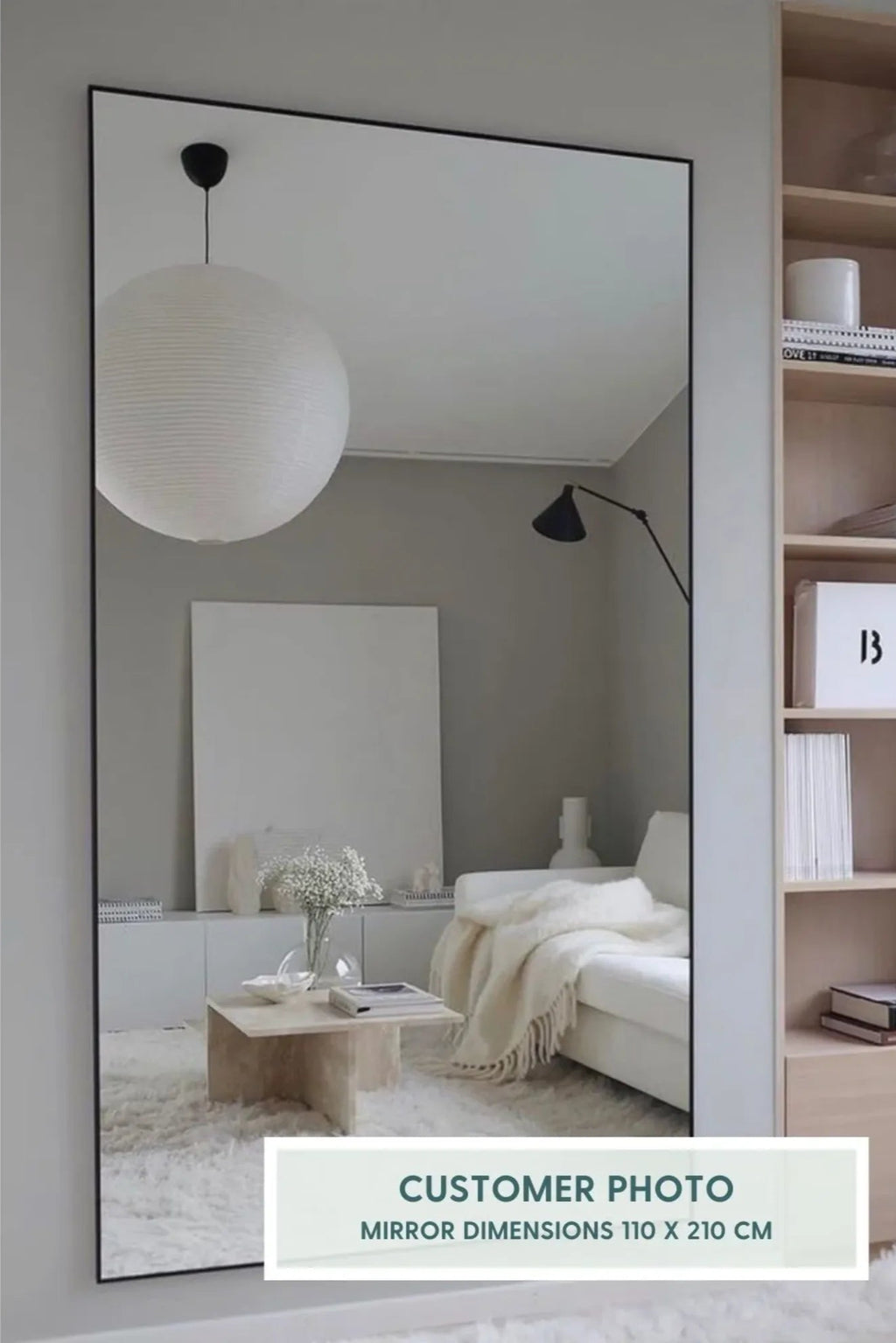 TCL Studios Sleek Full Length Mirror, a tall rectangular modern minimalist mirror featuring a thin matte black metal frame, providing a clean and contemporary aesthetic. This versatile black frame mirror is designed as a functional full-length floor mirror or large wall mirror, perfect for reflecting light and expanding spaces. Ideal for minimalist bedrooms, Scandinavian living rooms, or chic entryways seeking a stylish accent.