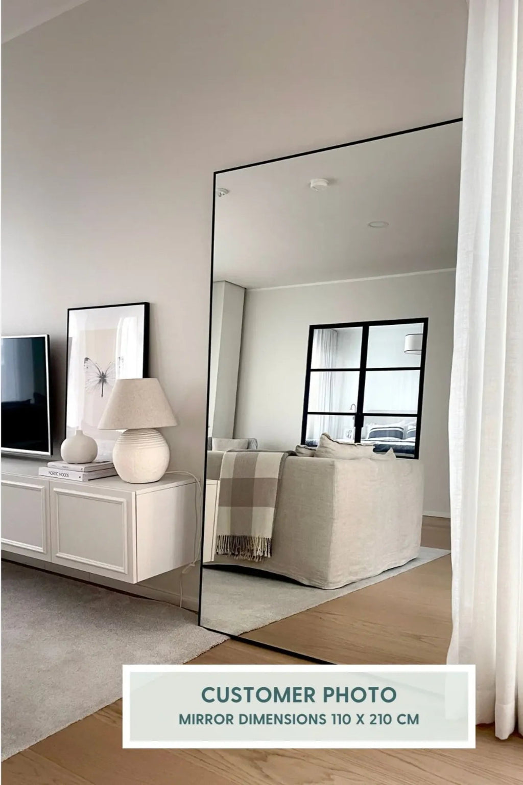 TCL Studios Sleek Full Length Mirror, a tall rectangular mirror measuring 110 x 210 cm, featuring a minimalist matte black metal frame and clear reflective glass, designed for modern.