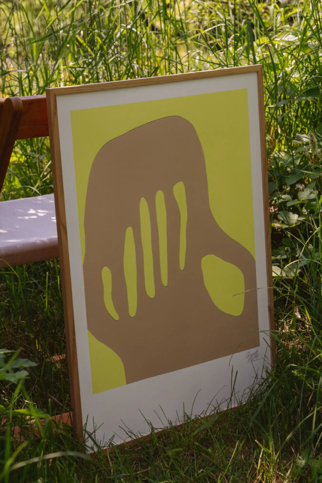 The Poster Club Summer in Marseille, a modern abstract art print featuring flowing organic taupe brown shapes against a vibrant chartreuse green background, presented with a clean white mat and framed in natural light oak wood.