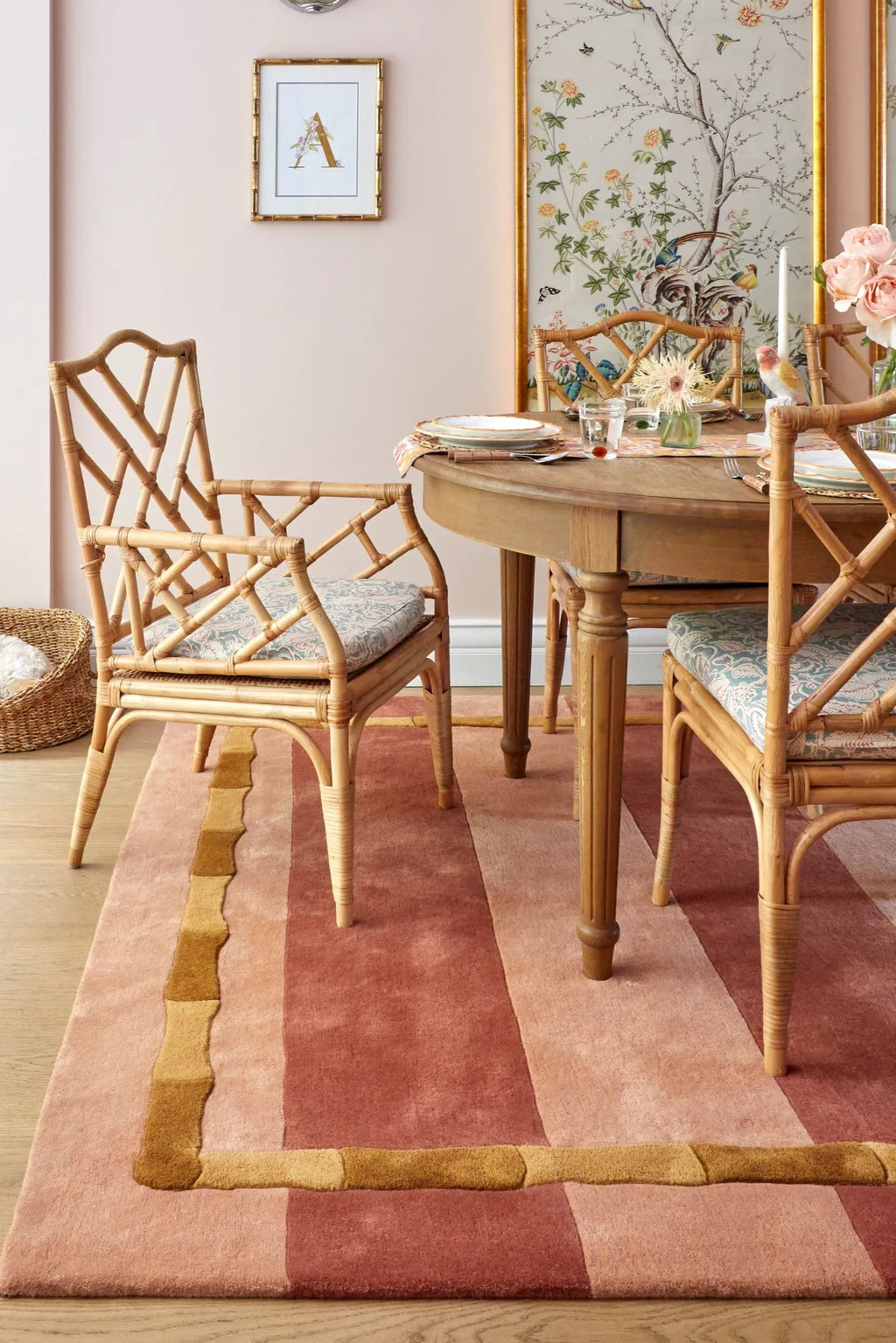 Layered Bamboo Stripe Wool Rug, featuring a modern abstract design with wide stripes in shades of pink, rose, and a golden yellow bamboo-like border. Perfect for adding warmth and contemporary styl...