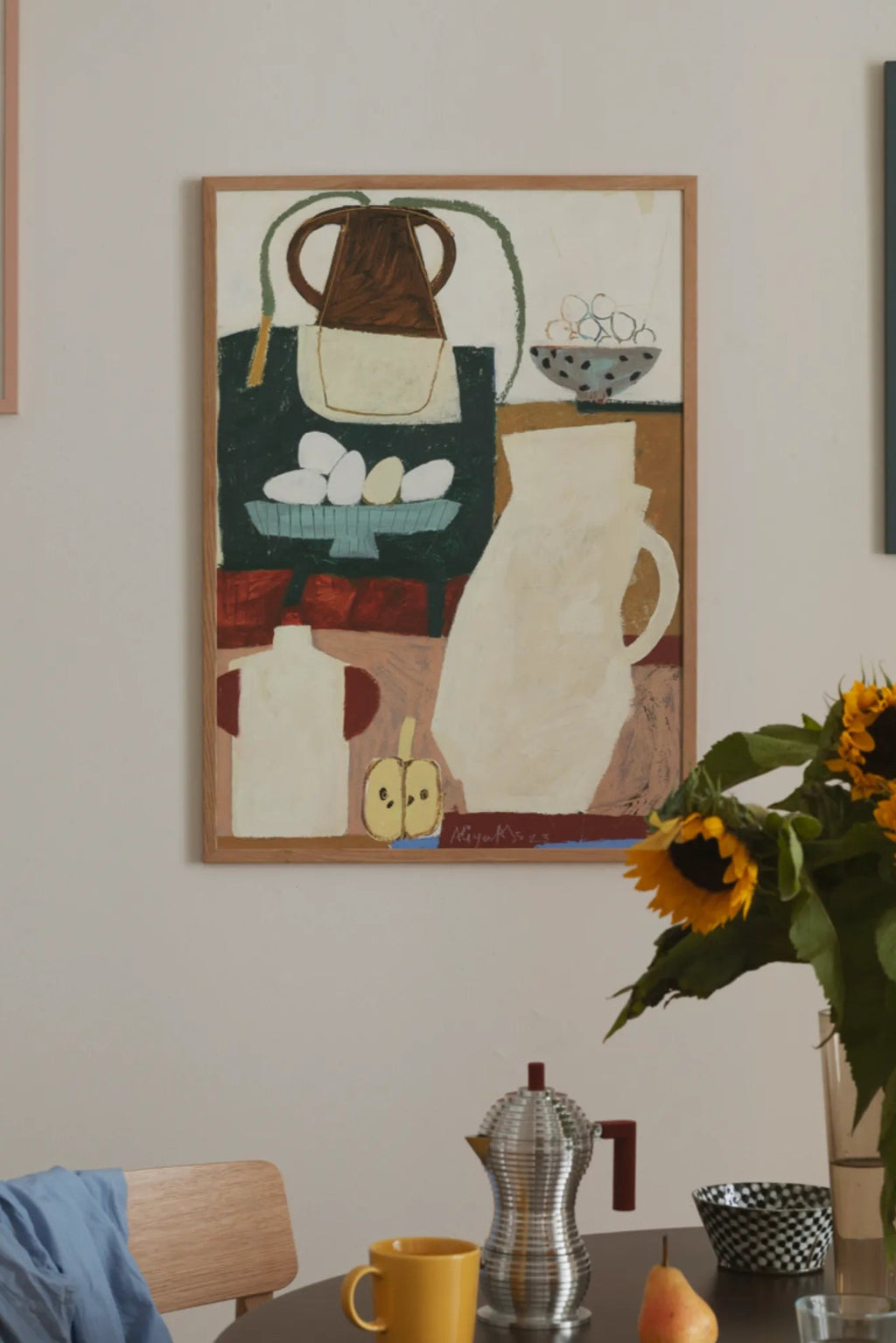 The Poster Club In the Kitchen at My Grandma, an abstract still life art print featuring kitchen essentials like a brown pitcher, a white jug, and a bowl of eggs, rendered in a charming folk art style.