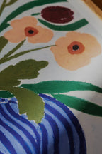 An elegant and serene still life painting titled 'Cerulean Still Life' featuring a collection of delicate blue and white ceramic vases and floral arrangements on a table