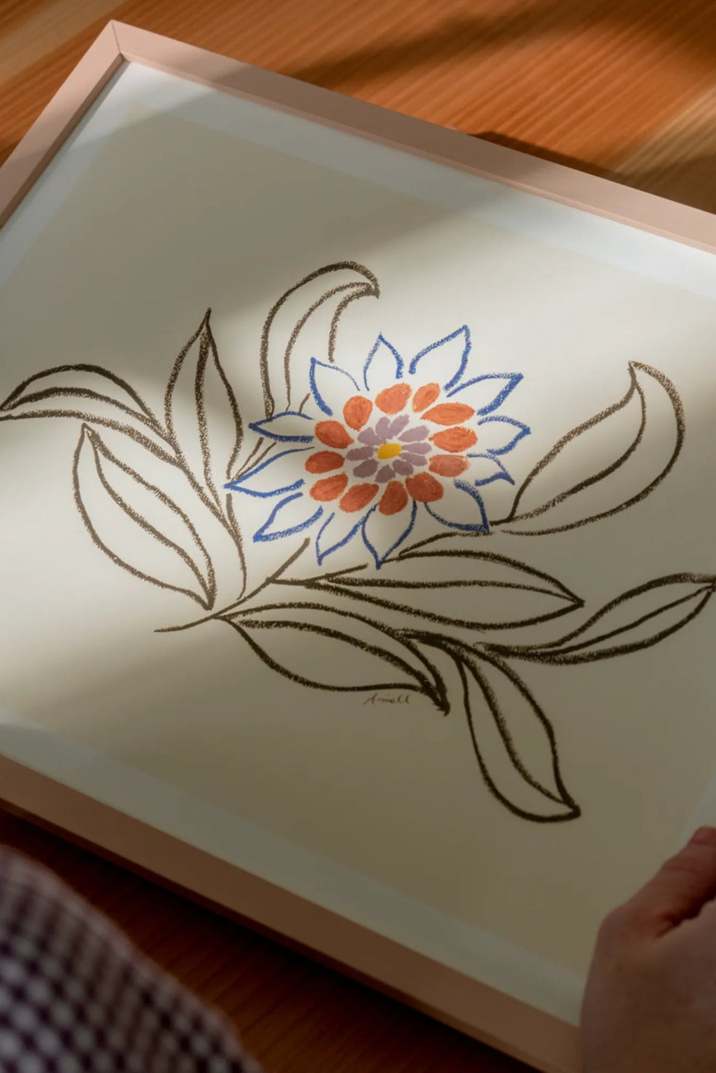 The Poster Club Nectar, a vibrant abstract floral art print featuring a stylized flower with blue, orange, and purple petals surrounding a yellow center, set against a cream background with dark brown illustrative leaves.