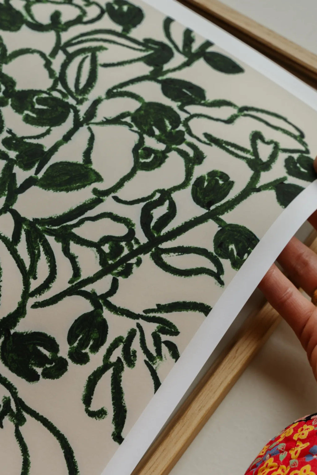 The Poster Club Poppy Studies II, an abstract botanical art print featuring bold, dark green brushstroke illustrations of poppy stems and leaves on a soft cream background, offering a contemporary organic feel. This minimalist floral poster is perfect for modern gallery walls, Scandinavian living rooms, or serene bedroom decor.