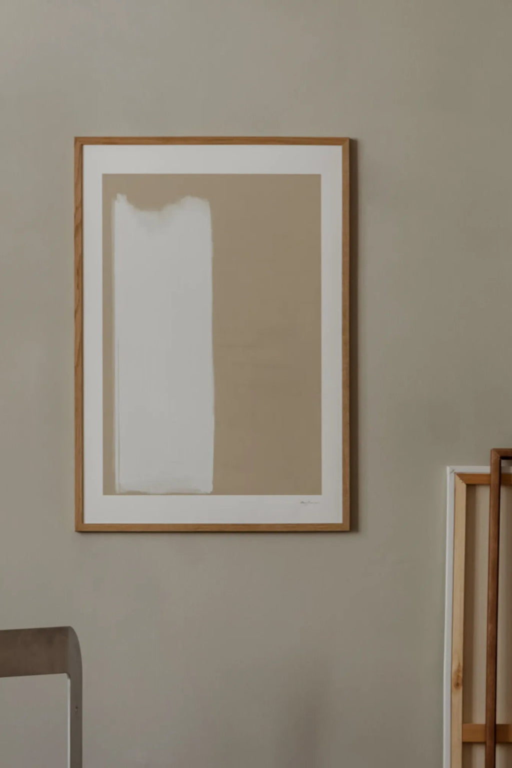 The Poster Club Fundamental, a modern minimalist abstract art print featuring a wide, textured off-white vertical brushstroke against a warm light beige background, beautifully framed in a natural oak frame with a crisp white mat. Ideal as contemporary wall art for Scandinavian living rooms, organic modern bedrooms, or elegant gallery walls.