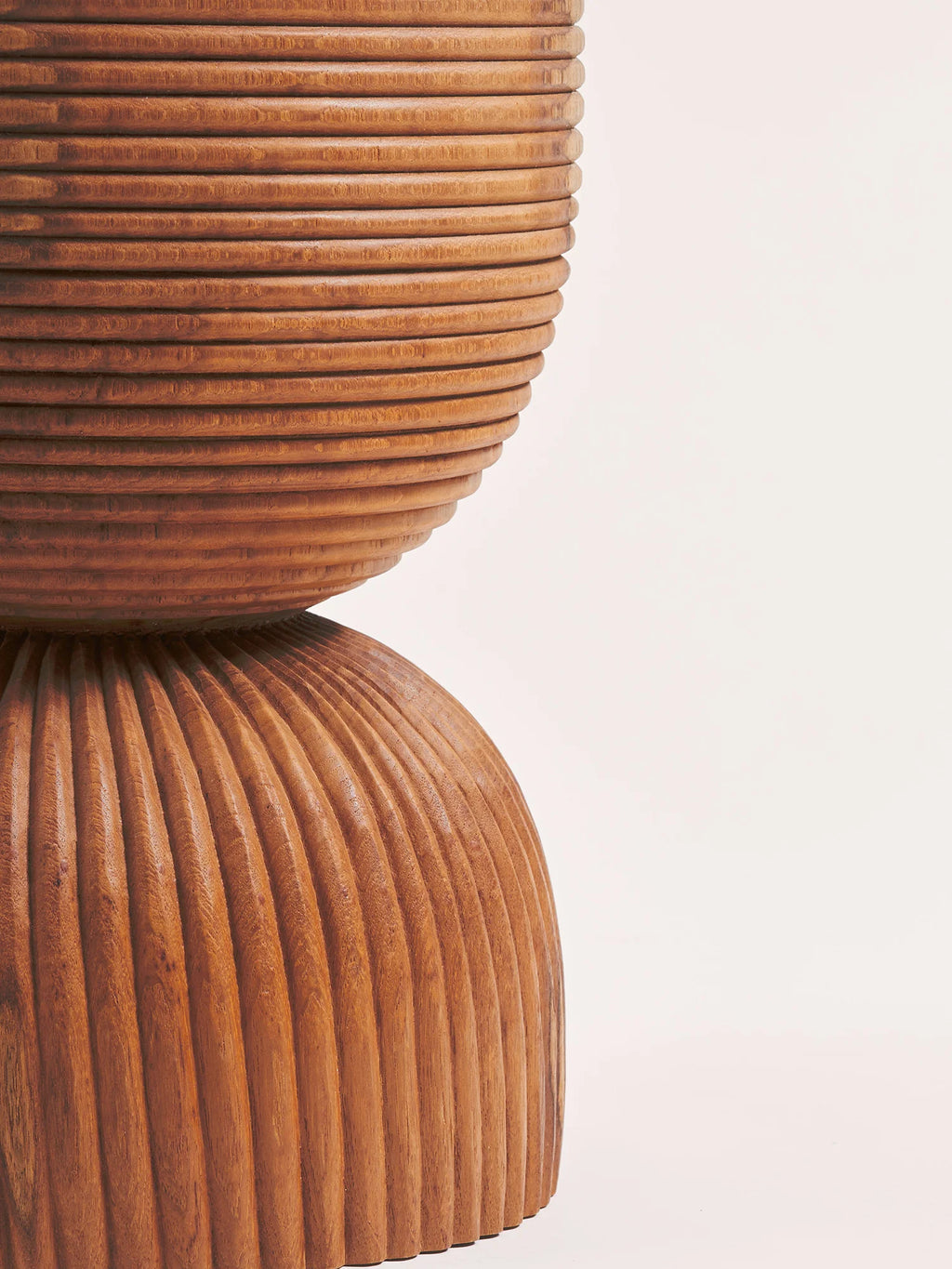 Heaps & Woods Anuk Stool, a striking organic modern accent stool crafted from richly textured solid wood in warm brown tones. It features a unique hourglass silhouette with a fluted, carved base and a top composed of stacked horizontal rings, offering a tactile, sculptural design. This contemporary wood stool is perfect as a side table or decorative accent for living rooms, bedrooms, or entryways.