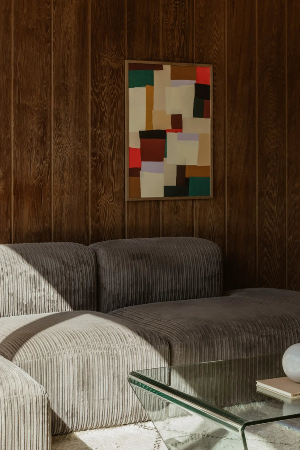 The Poster Club Fields, a vibrant abstract art print featuring a dynamic collage of geometric color blocks in warm earthy tones like cream, beige, and brown, accented with bold pops of red, deep green, and light purple, framed in a natural wooden frame with a crisp white mat. This modern abstract wall art is perfect for adding a contemporary touch to living rooms, mid-century inspired spaces, or curated gallery walls.