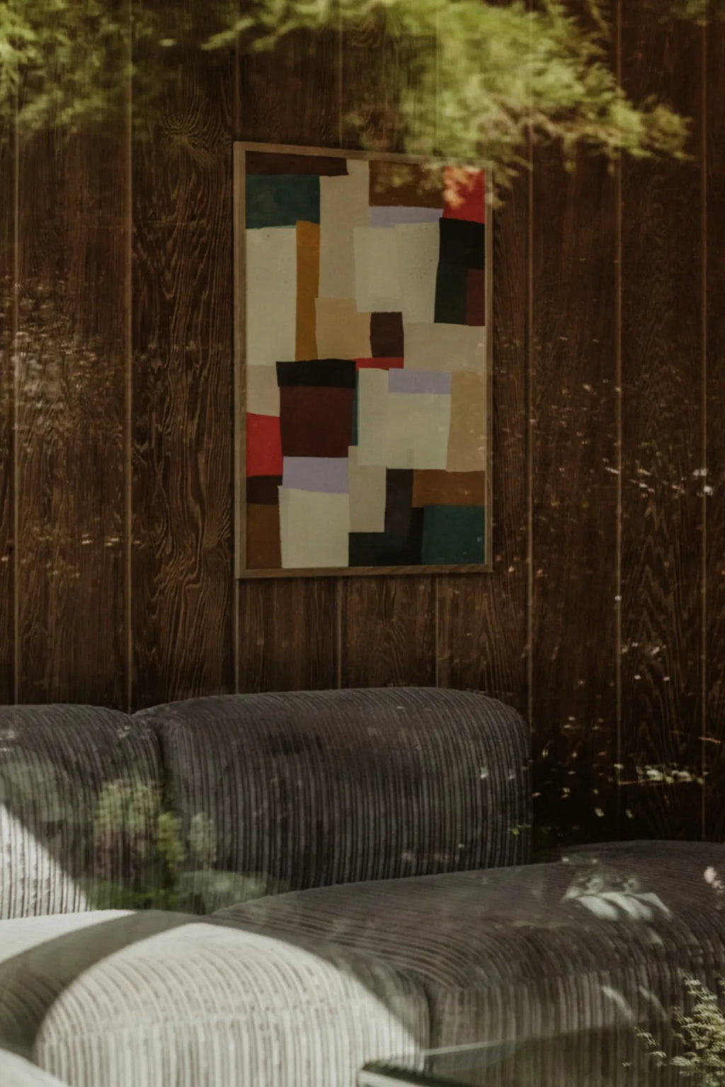 The Poster Club Fields, an abstract geometric art print showcasing a modern composition of multi-colored rectangular blocks in a rich, earthy palette of muted beige, sage green, burgundy, black, and terracotta, framed in a subtle natural oak frame.
