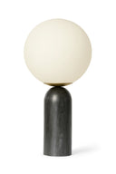 Table lamp with a spherical white shade and dark wooden base on a white background