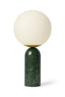Table lamp with a spherical cream top and green base on a white background