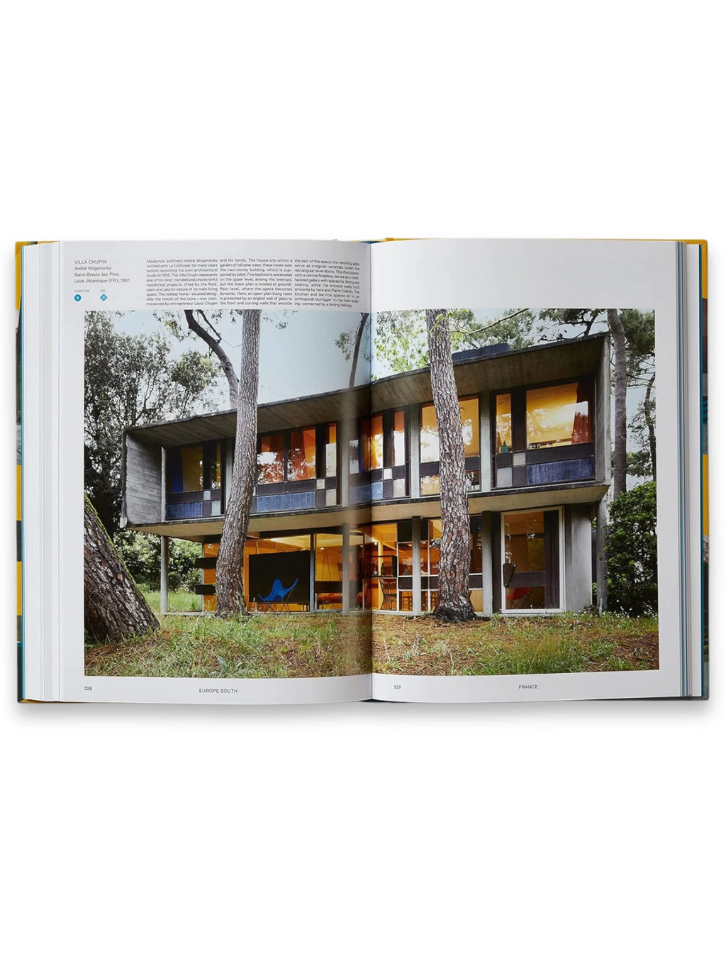 Book Atlas of Mid-Century Modern Houses, featuring an open page showcasing a stunning concrete and glass mid-century modern home nestled among pine trees. This hardcover architecture book is a perfect resource for design enthusiasts and architectural history buffs.