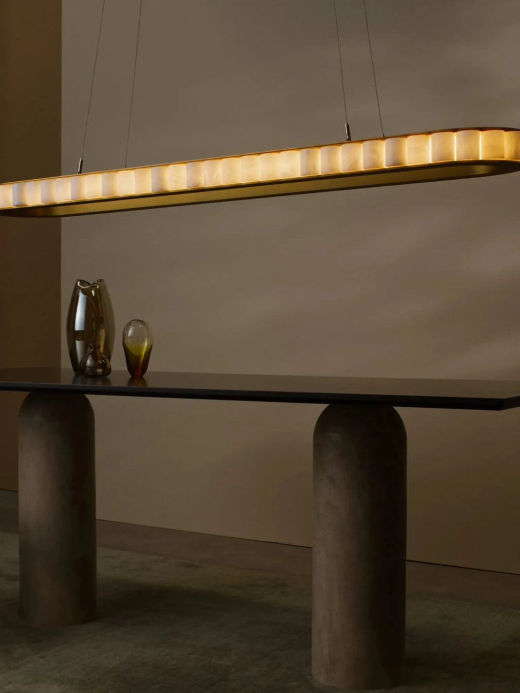 CTO Lighting Avalon Oval Pendant Light, a luxurious contemporary linear suspension light featuring an elongated oval brushed brass frame with glowing translucent alabaster panels arranged in a striking segmented design.