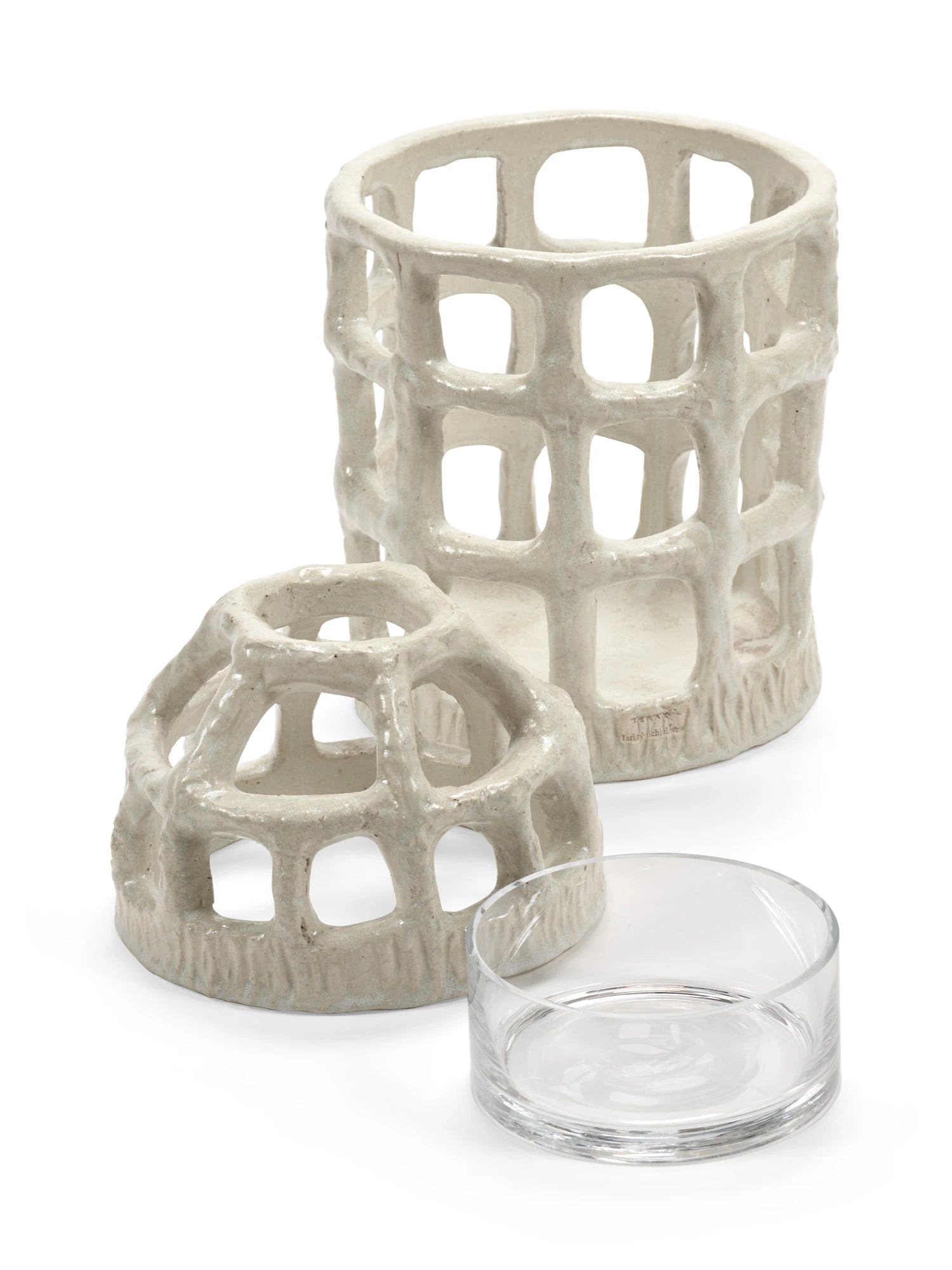 Two ceramic candle holders with a glass candle holder on a white background