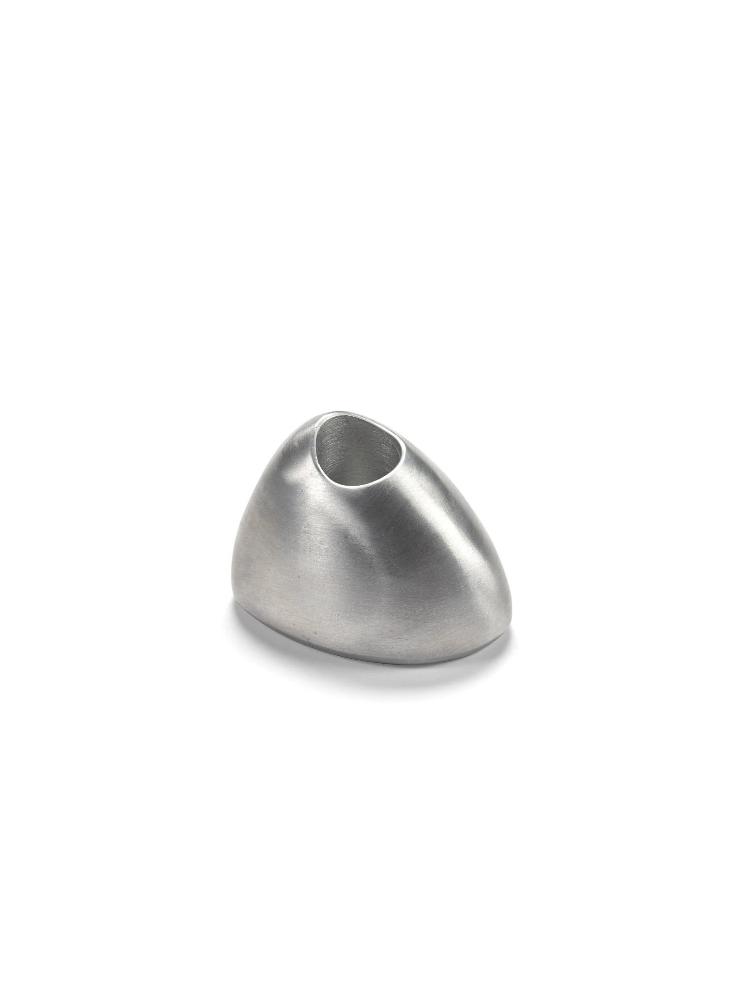 A studio shot of a single Out of Lines Candle Holder made of brushed silver or pewter metal. The holder has a smooth, organically rounded, pebble-like shape with a small, circular opening at the top for a candle. It is photographed on a white background with a soft shadow beneath it.