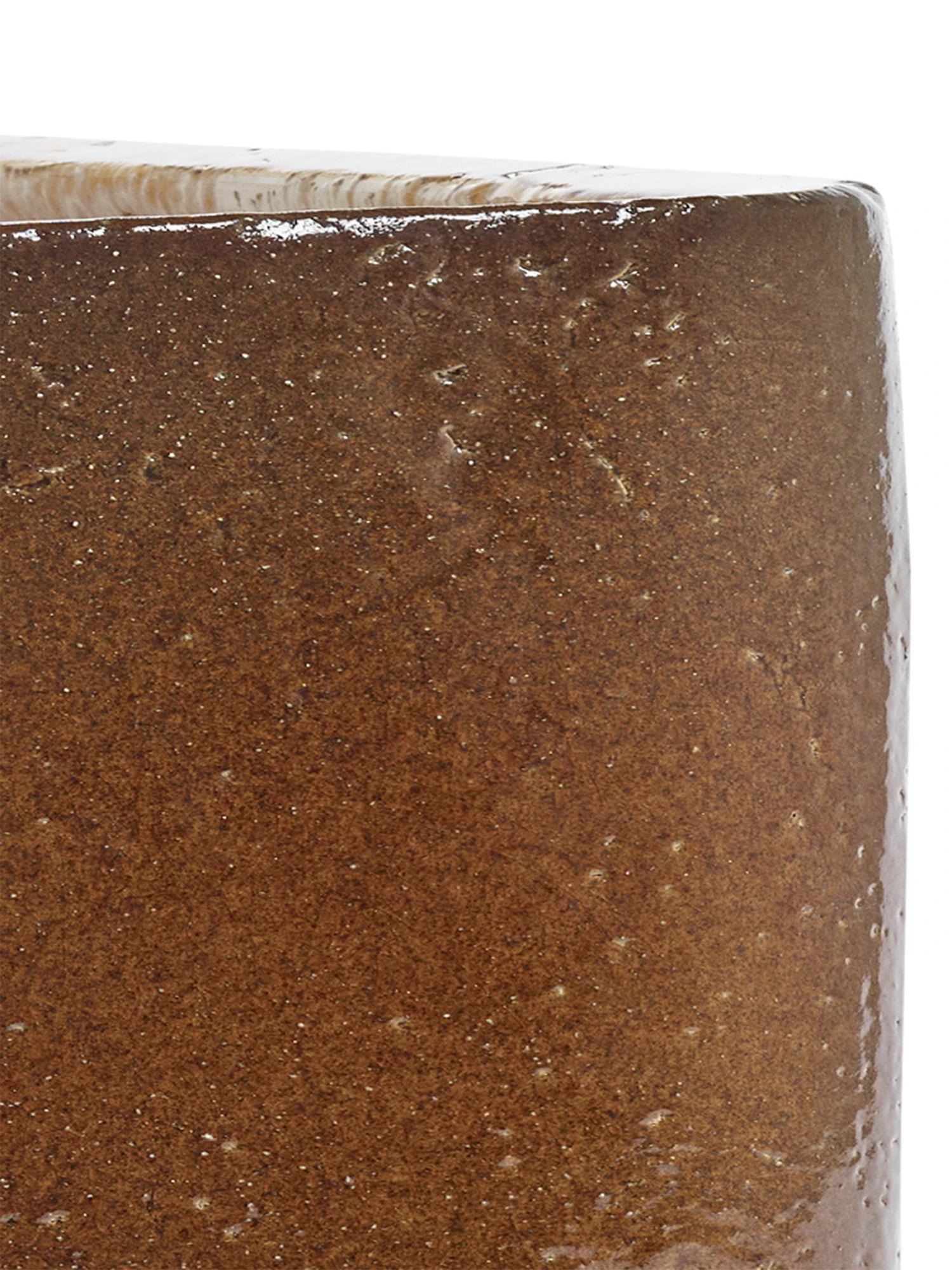 Close-up of a brown ceramic tile with a textured surface