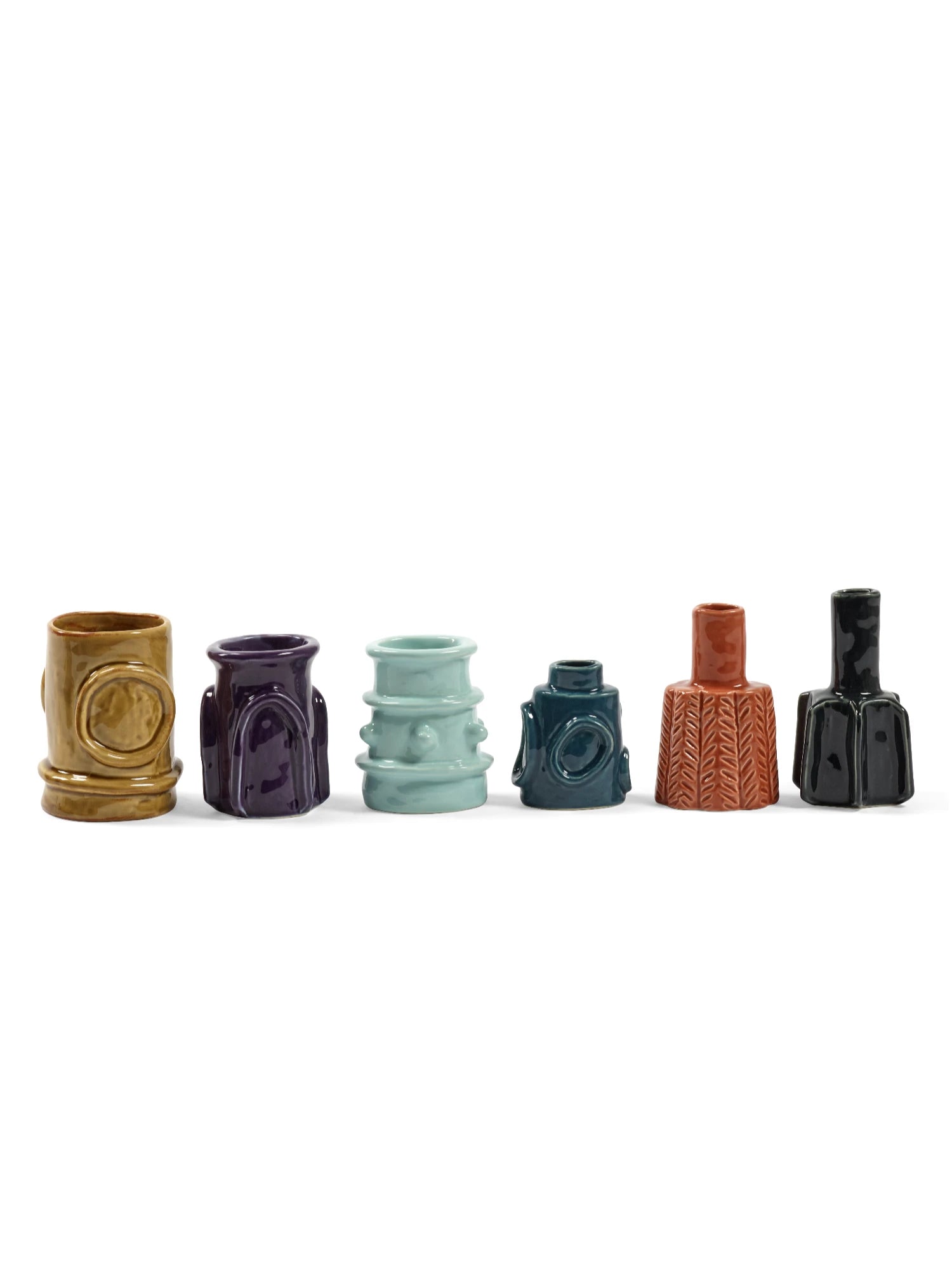 Set of six ceramic vases in various colors on a white background