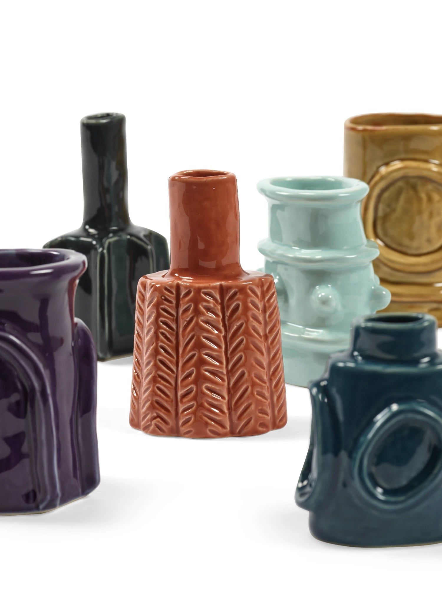 Collection of various ceramic vases on a white background