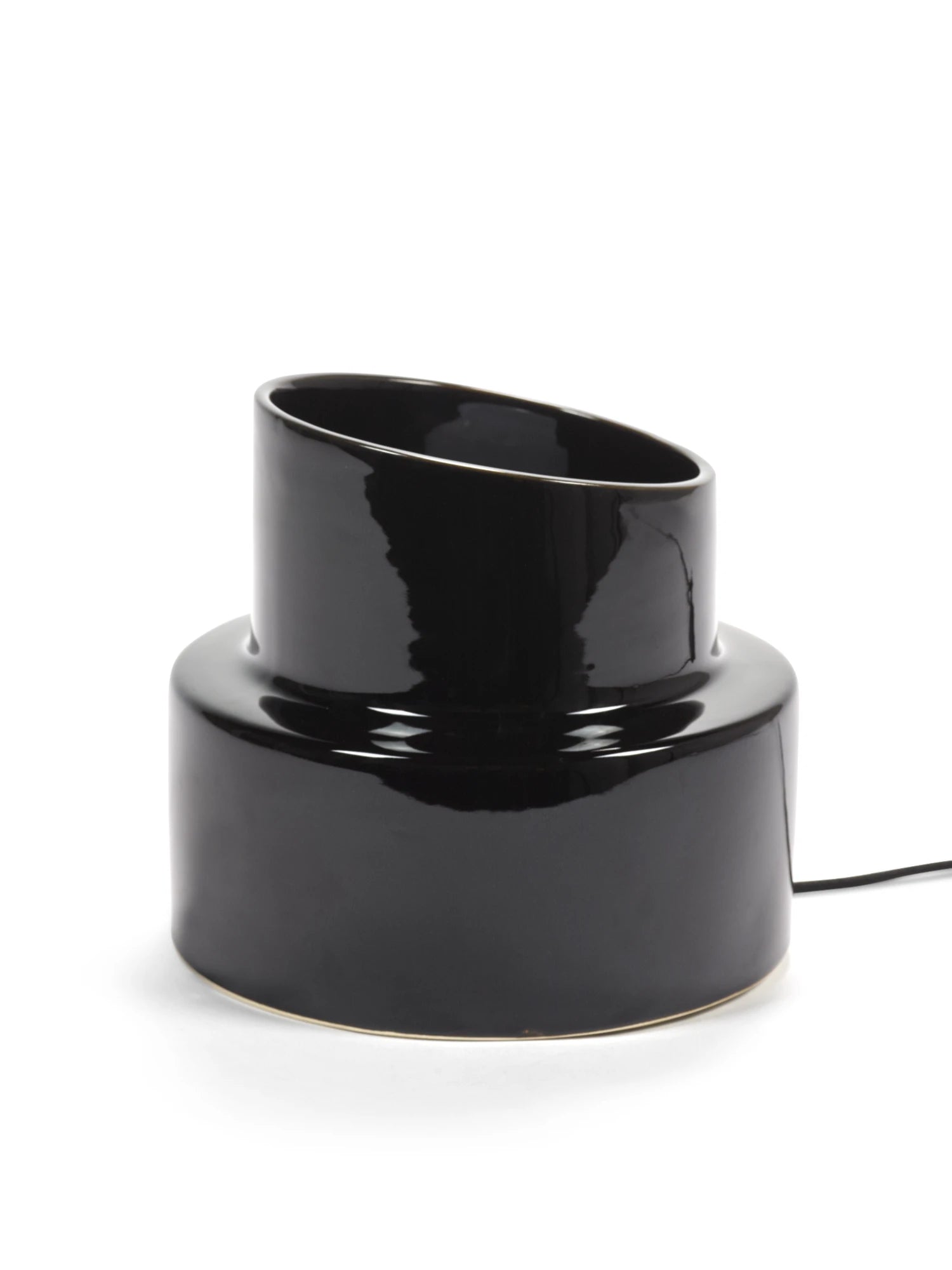 Black cylindrical lamp with a curved design on a white background