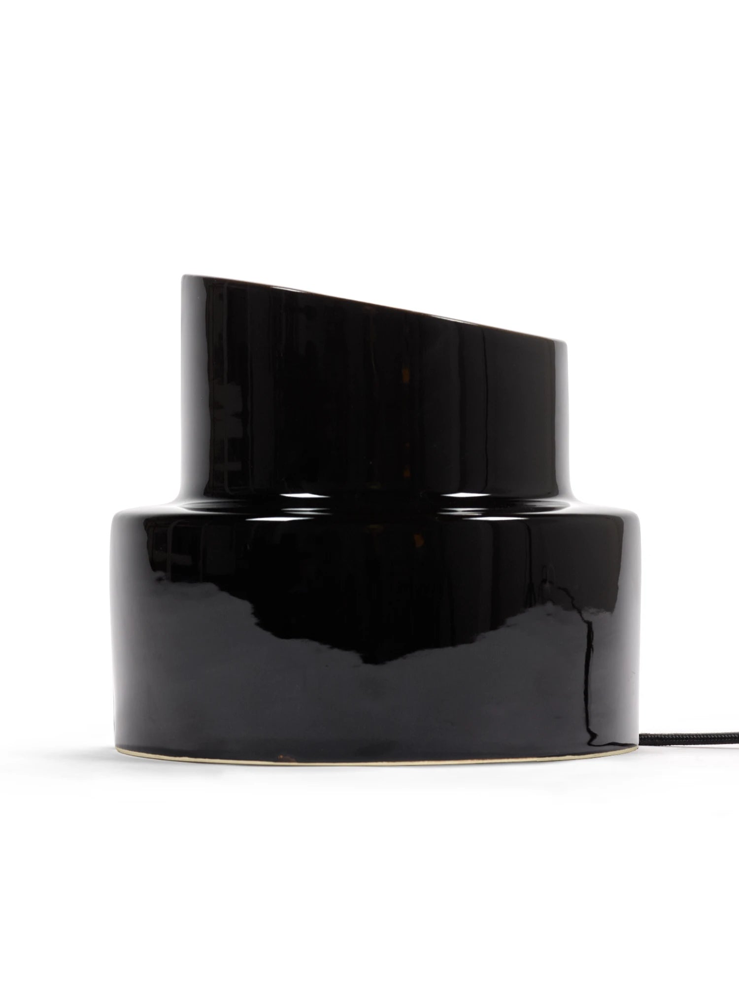 Black cylindrical lamp on a white background