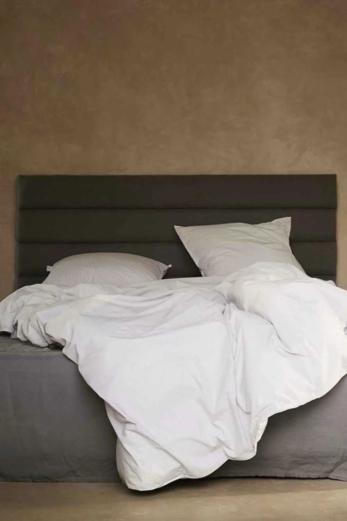Beautiful linen headboard in neutral color, perfect for adding a touch of elegance to any bedroom decor