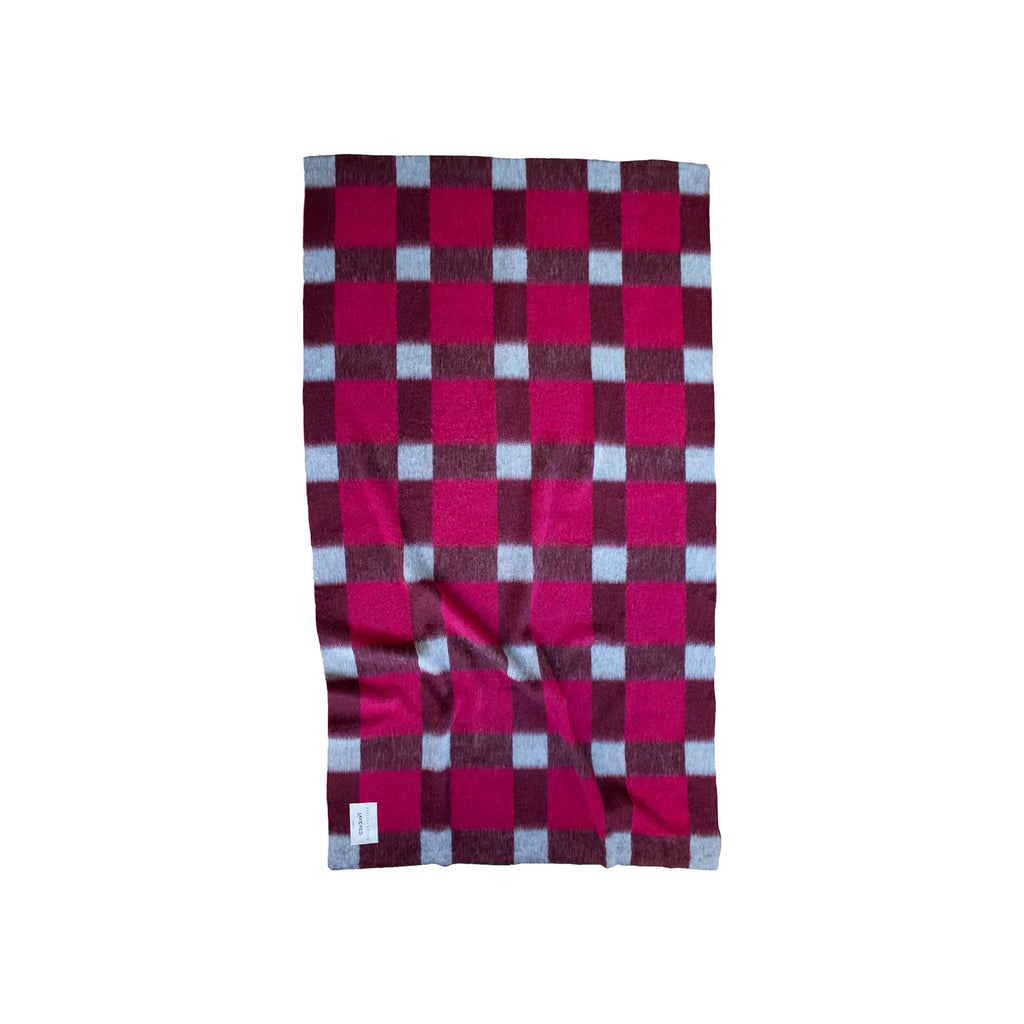 Layered Dancing Doll Oversized Throw Blanket, a soft, fuzzy pink, maroon, and light blue plaid checkered pattern throw with a visible brand tag. Perfect for adding a cozy, vibrant accent to any liv...