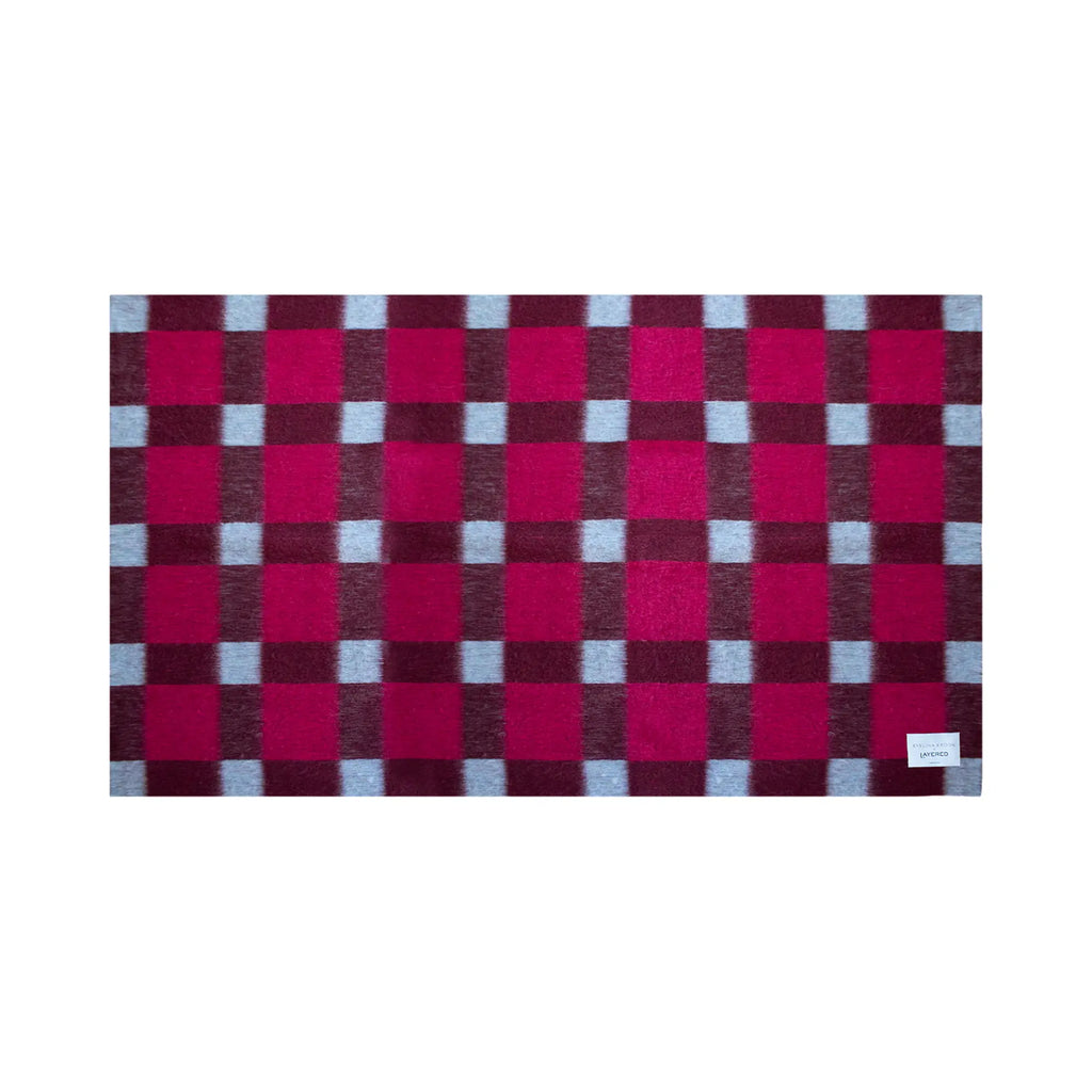 Layered Dancing Doll Oversized Throw Blanket, a soft, cozy textile in a vibrant fuchsia, burgundy, and light blue checkered plaid pattern. Perfect for adding warmth and a pop of color to any living...