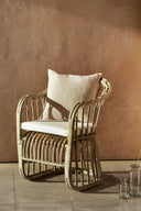 Two elegant rattan dining chairs with comfortable padded seats