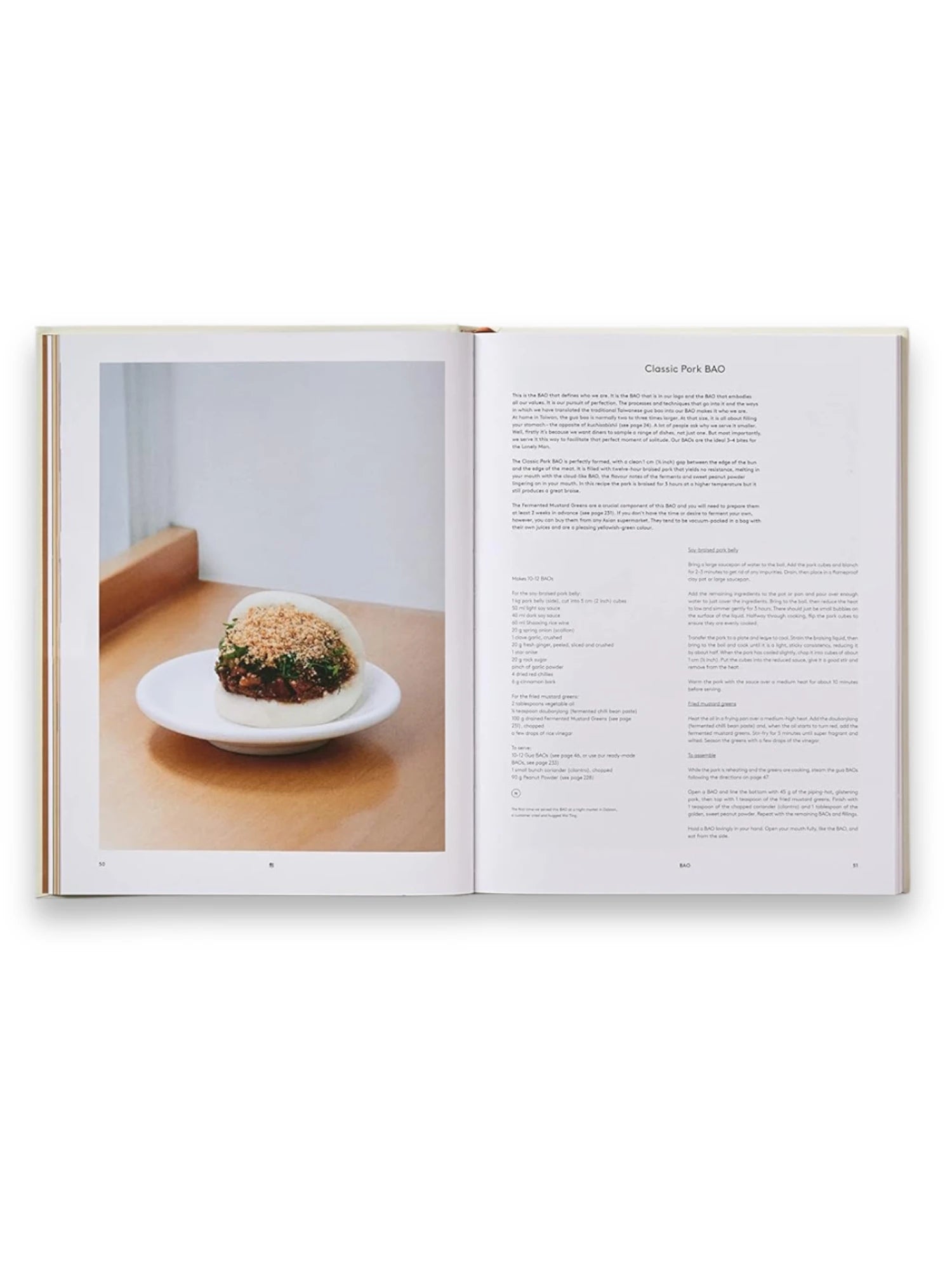 Book Bao, an open cookbook featuring a mouth-watering image of a classic steamed pork bao bun on a white plate, alongside detailed recipes and cooking instructions. This culinary cookbook is perfect for home chefs and food enthusiasts eager to master authentic Asian cuisine.