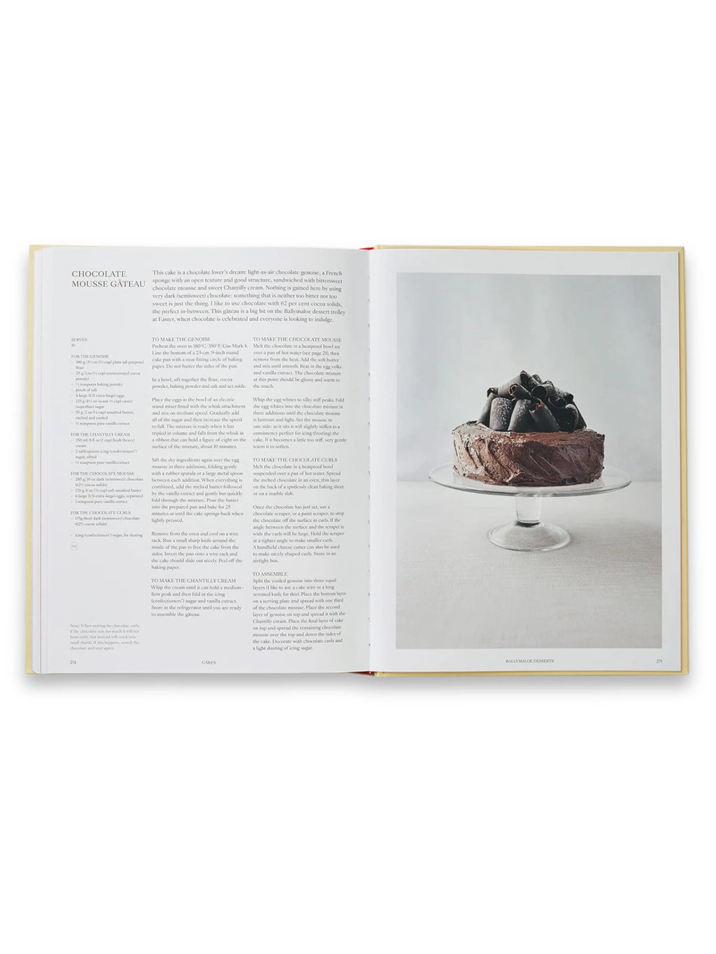 Book Bao, an open cookbook displaying a delicious Chocolate Mousse Gâteau recipe with a stunning full-page image of a rich, dark chocolate cake topped with elegant chocolate curls on a clear glass cake stand. This beautiful culinary guide is perfect for home bakers and dessert enthusiasts seeking gourmet recipes.