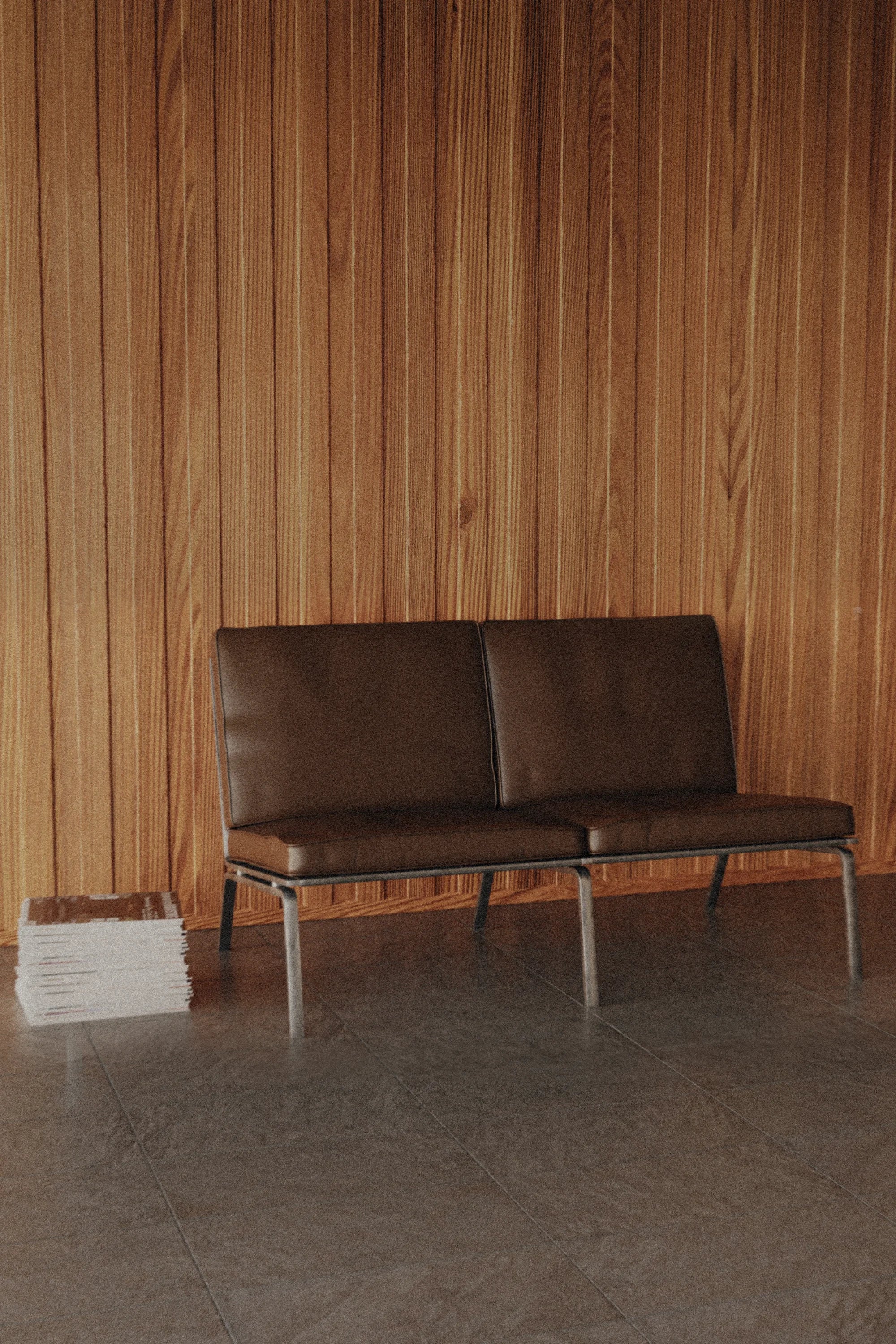 Brown leather sofa against a wooden paneled wall.