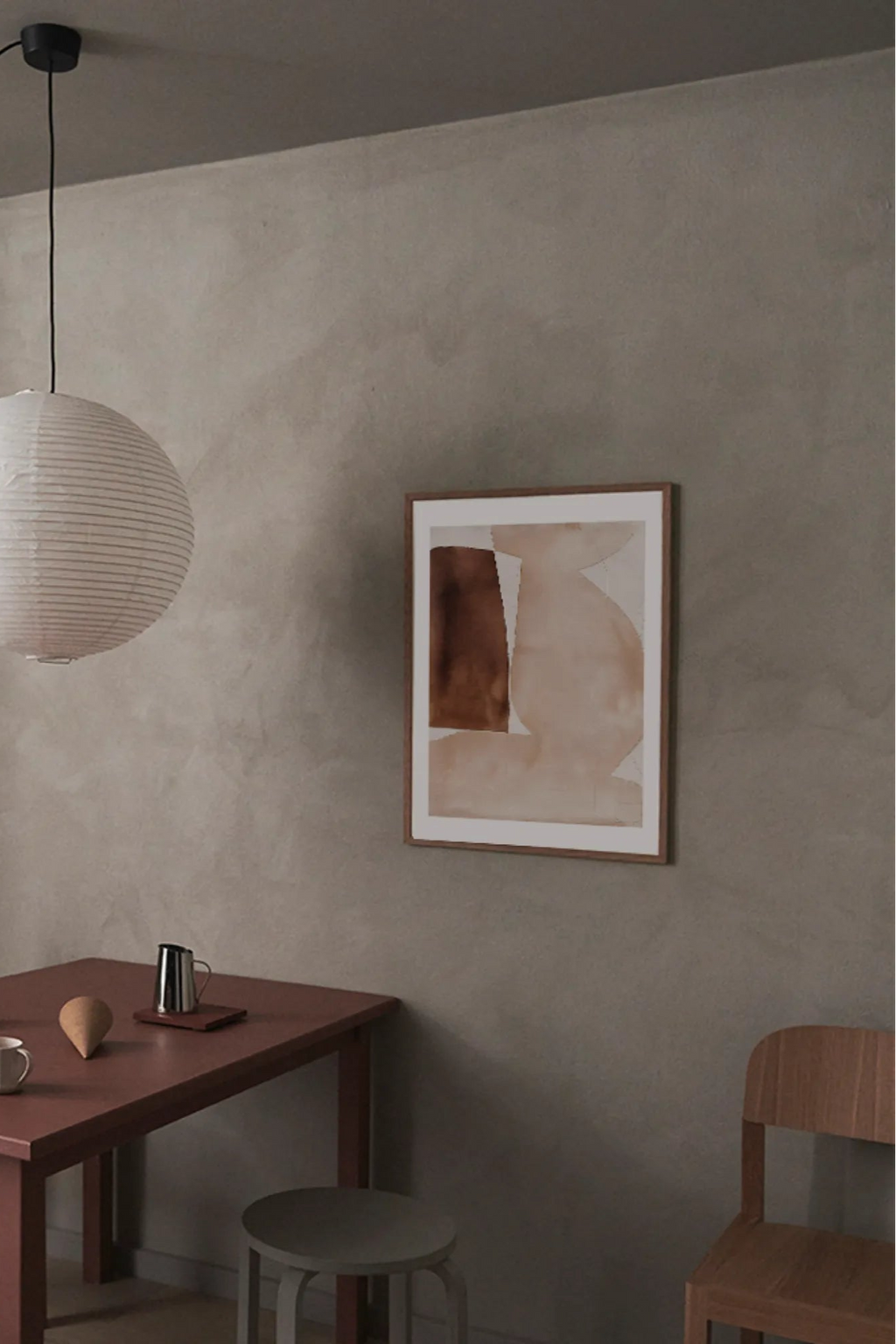 The Poster Club Bloom, an abstract art print featuring soft, organic shapes in a warm neutral palette of deep brown and light beige tones, set within a natural wood frame with a crisp white mat. This contemporary wall art is perfect for adding a serene and minimalist focal point to modern living rooms, Scandinavian bedrooms, or japandi-inspired gallery walls.