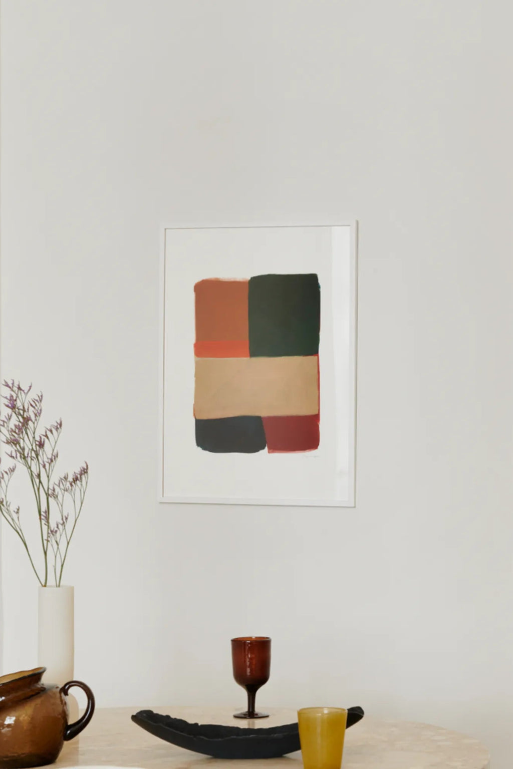 The Poster Club Colour Squares 02, an abstract art print featuring a geometric composition of warm earth tones including terracotta, olive green, beige, black, and deep red blocks with painterly textures, framed in a clean white frame with a white mat. This contemporary wall art is ideal for minimalist living rooms, modern dining rooms, or gallery walls seeking a sophisticated color palette.