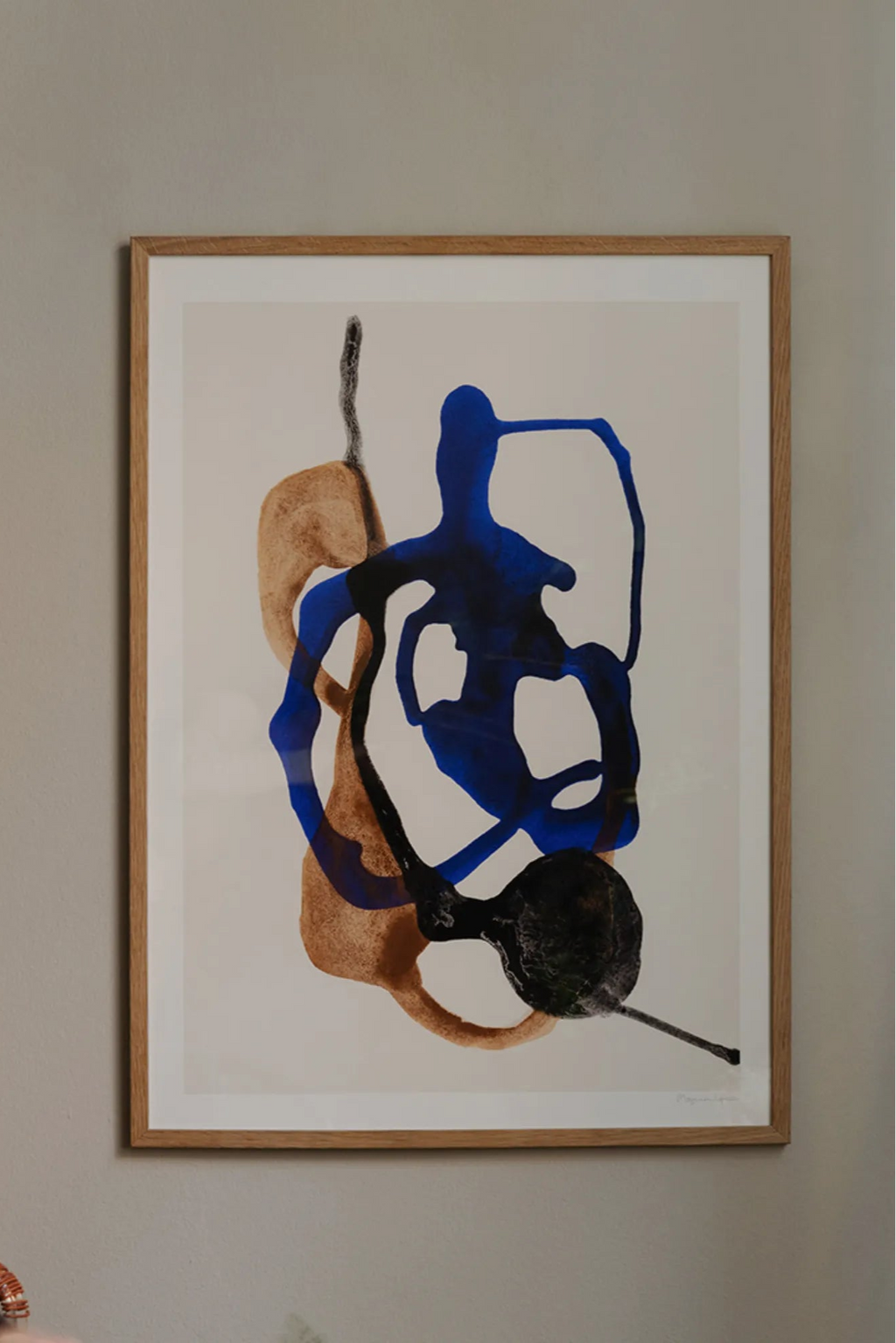 The Poster Club Float, a contemporary abstract art print featuring fluid, organic shapes in vibrant royal blue, warm brown, and deep black against a crisp white background. This striking piece is presented in a natural oak frame with a clean white mat, creating a sophisticated look. Perfect for adding organic modern wall art to minimalist living rooms, bedrooms, or gallery walls.