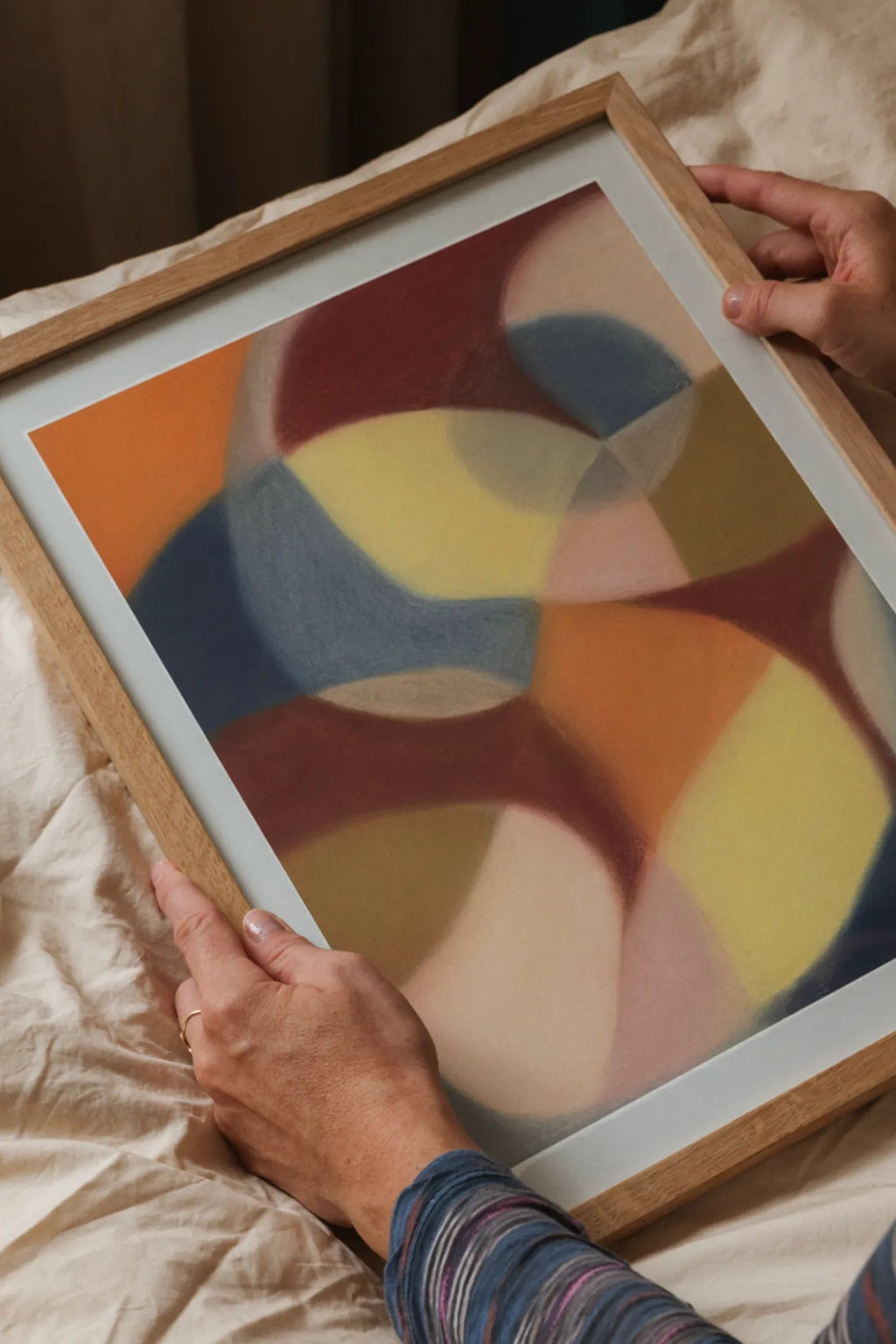 The Poster Club Increase, a contemporary abstract art print featuring organic, overlapping circular and curved shapes in a muted, earthy color palette of terracotta orange, deep yellow, muted blue, and burgundy. This modern minimalist poster is framed with a light natural oak frame and a crisp white mat. Perfect as stylish wall art for Scandinavian living rooms, Japandi bedrooms, or a curated gallery wall in a home office.